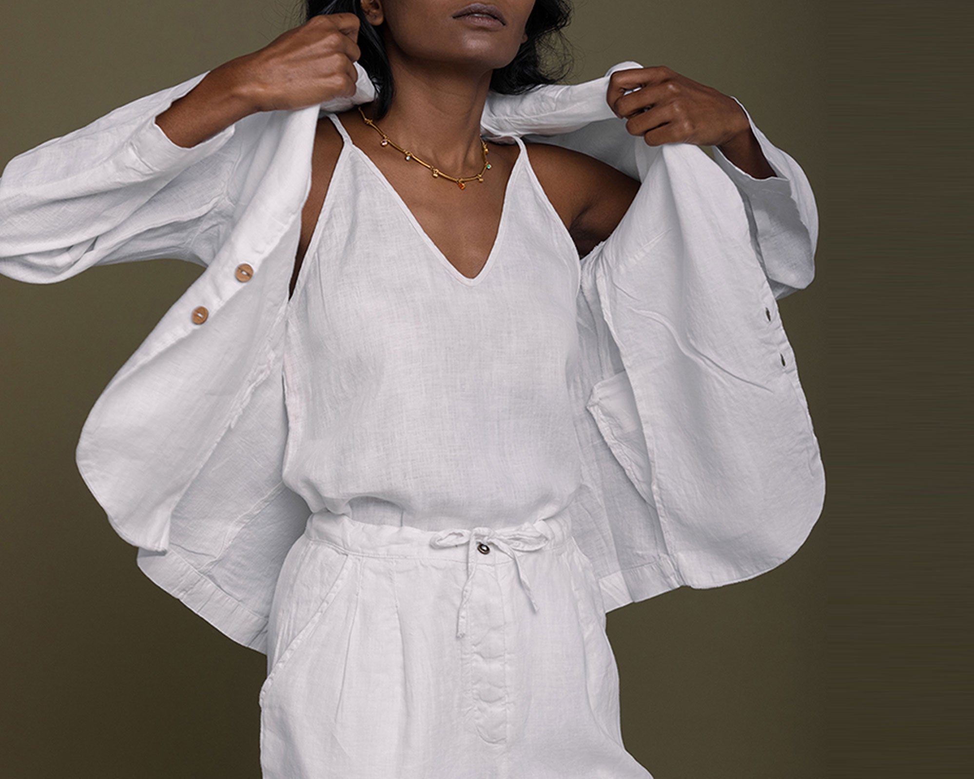 Woman wearing a white outfit with a plain background