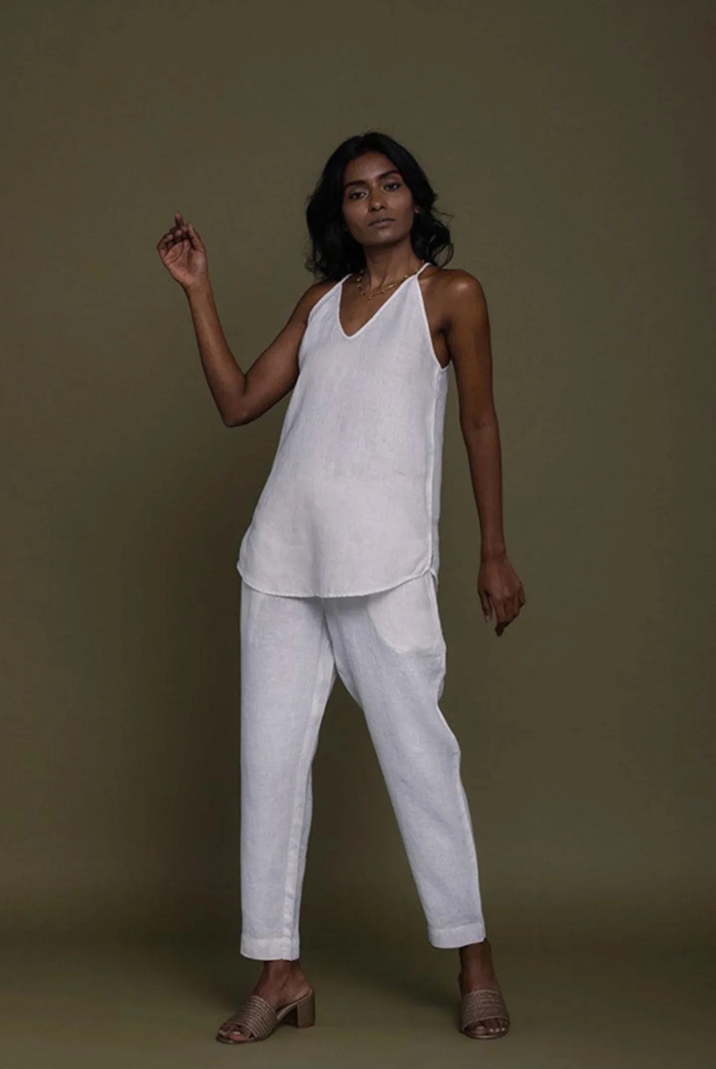 Reistor sleeveless white co-ord set with V-neck top and tapered pants, sustainable women's fashion with a relaxed fit.