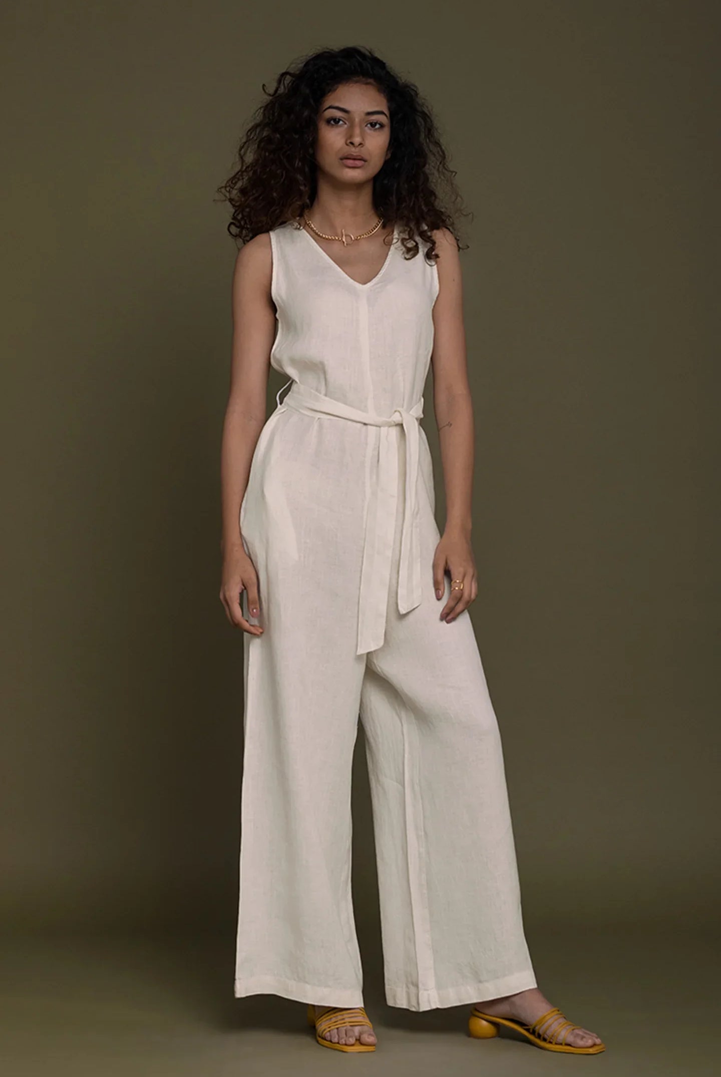 Reistor sleeveless neutral beige belted jumpsuit with wide-leg fit, sustainable women's fashion for timeless style.