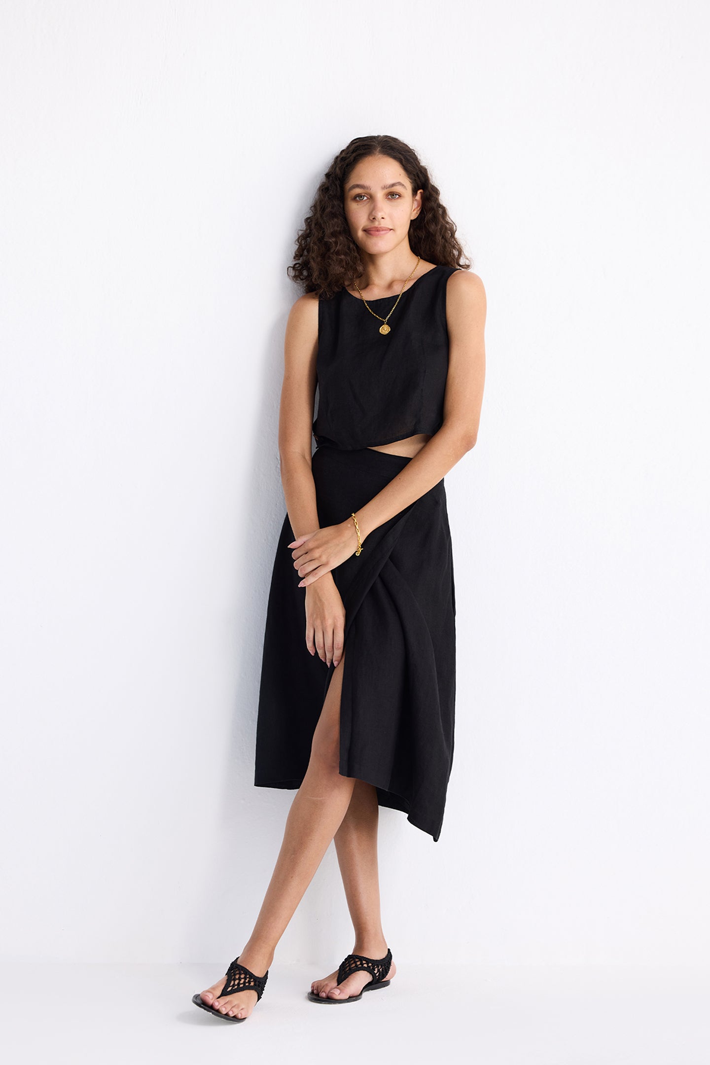 Front view of model wearing Reistor Breezy Summer Set in Black, featuring a sleeveless crop top and high-waisted midi skirt with a relaxed, airy summer silhouette.