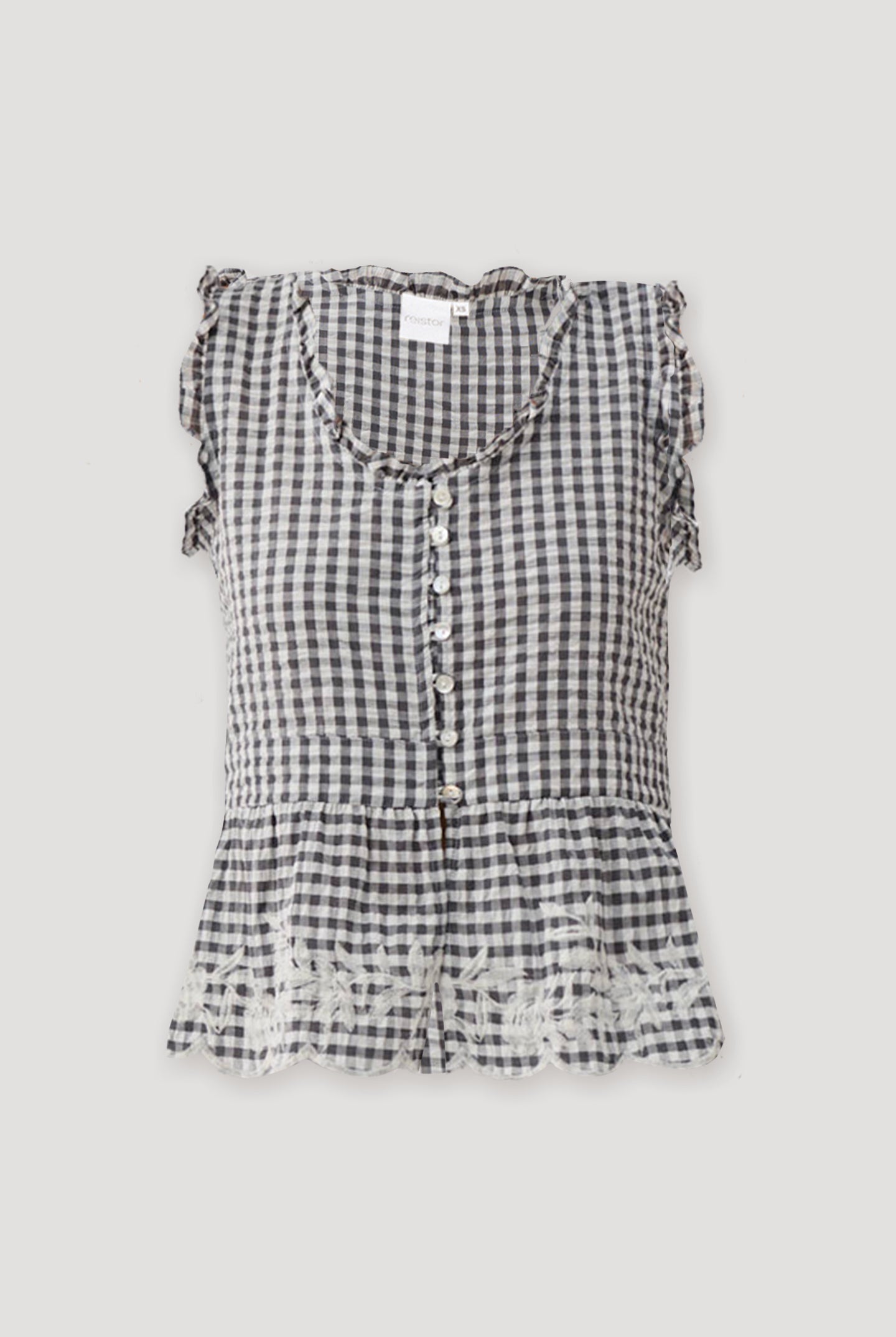 Embroidered peplum top in grey check featuring a sleeveless design, ruffled trim at the neckline and armholes, front button closure, and a flared peplum hem with delicate embroidered detailing.
