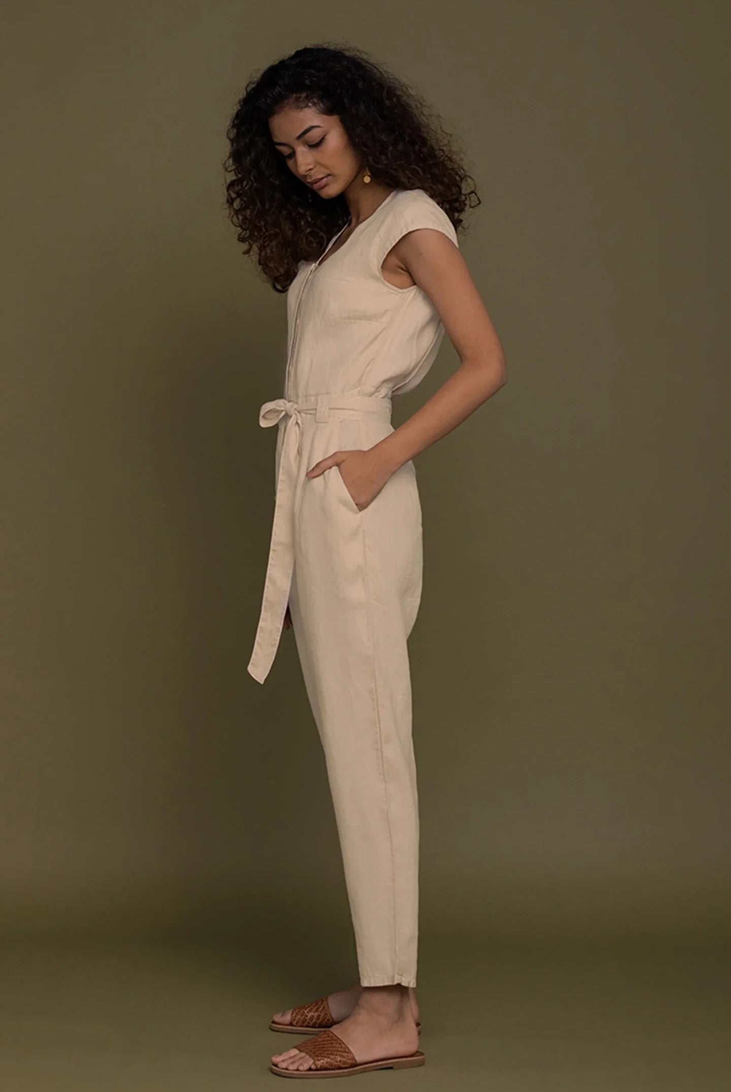 Reistor Evening Chai Jumpsuit in Neutral Beige for women, side profile with tie waist, pockets and relaxed fit