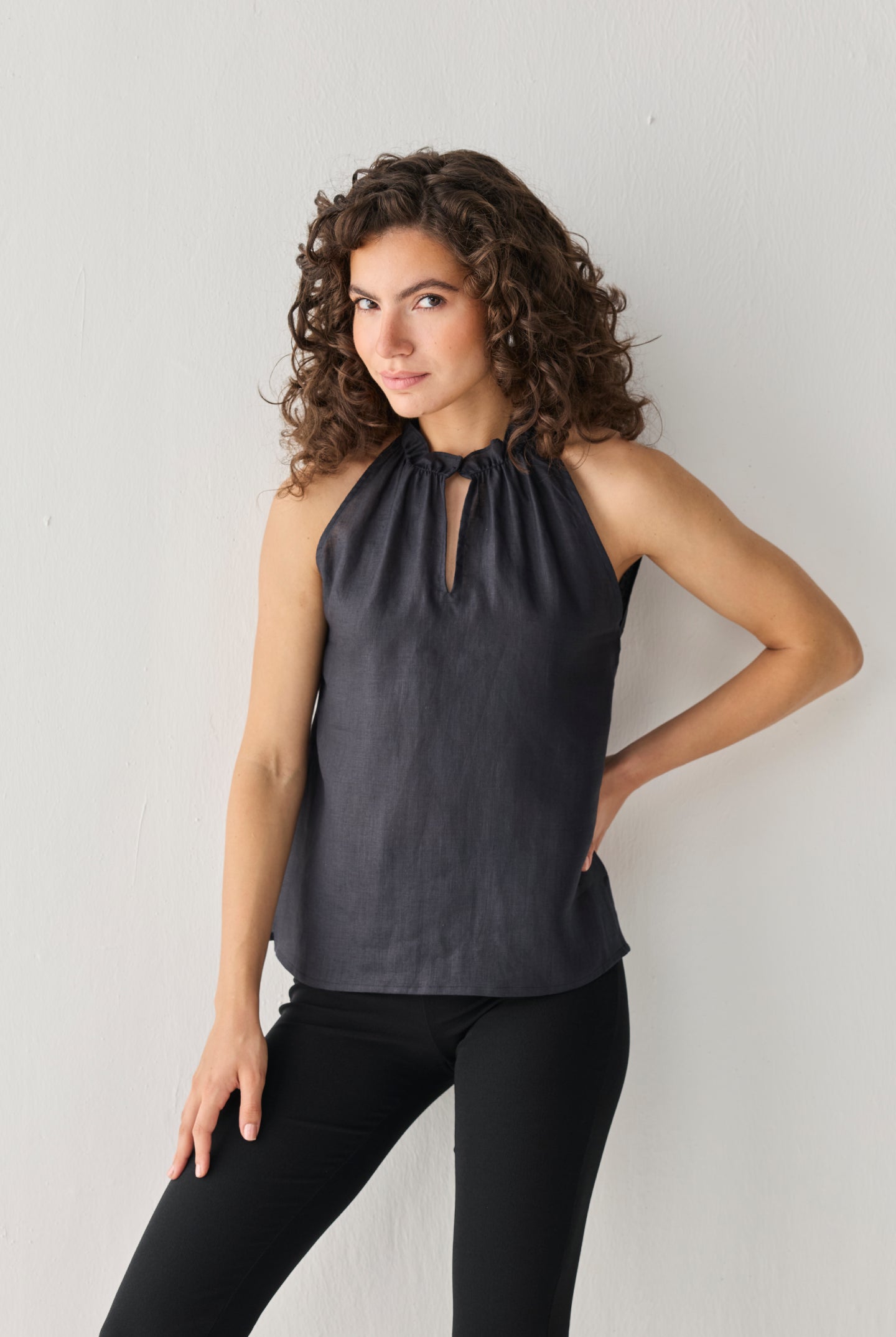 Reistor Halter Neck Top in Black with a softly gathered neckline and keyhole detail, crafted in breathable fabric for an elegant, versatile look.