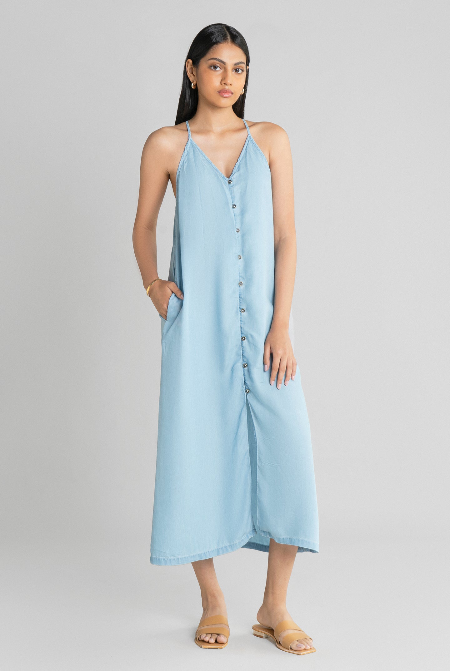 Reistor In the Mood for Love Denim Midi Dress featuring a relaxed sleeveless fit, premium lightweight denim, button-front styling and a graceful midi length.