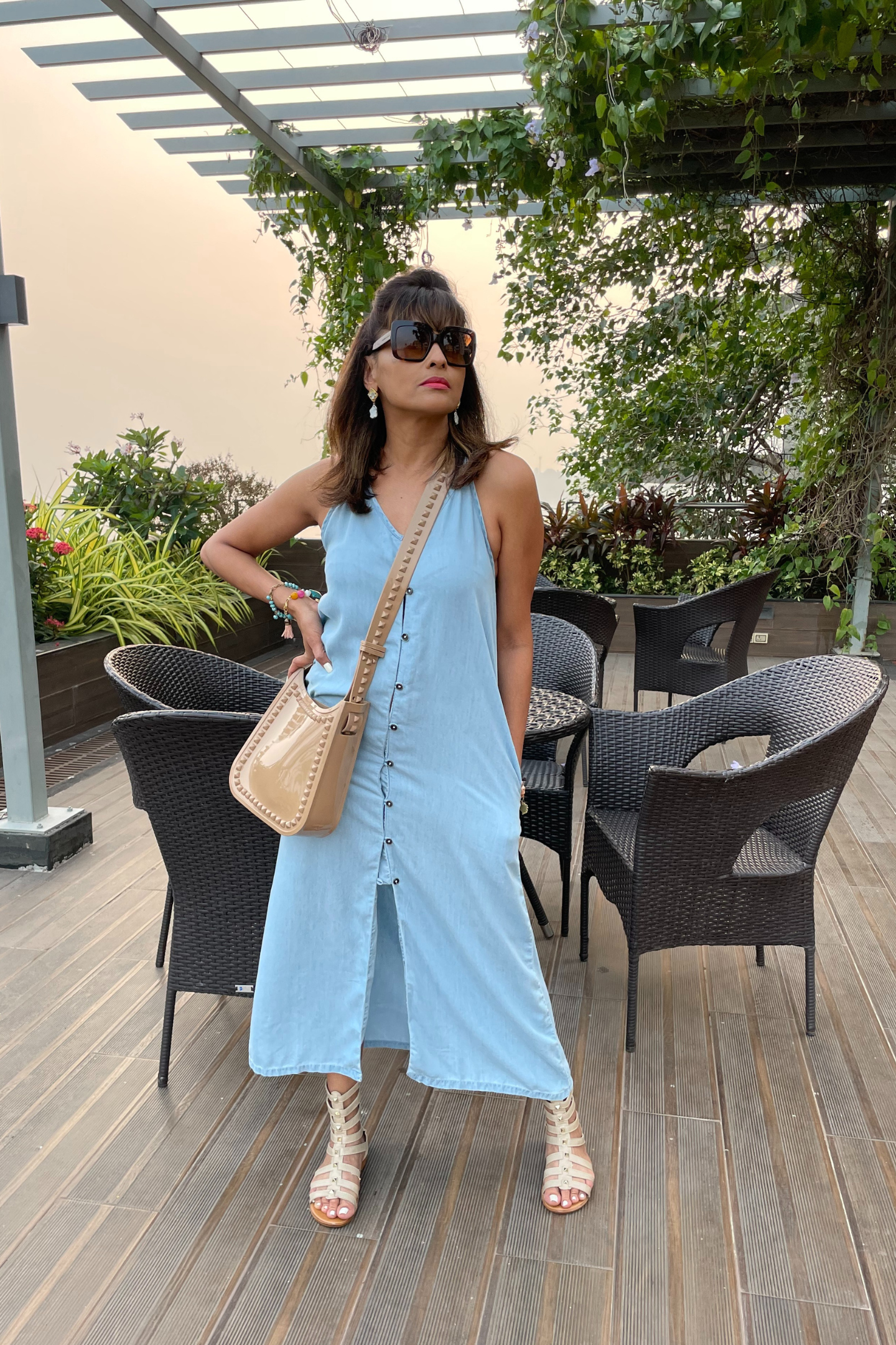 Reistor In the Mood for Love Denim Midi Dress in soft blue, styled with a crossbody bag and strappy sandals for a chic, effortless daytime summer look.