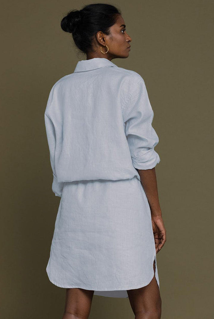 Meet Me by the Cliff Dress in Blue by Reistor, back view of a sustainable blue shirt dress for women with long sleeves
