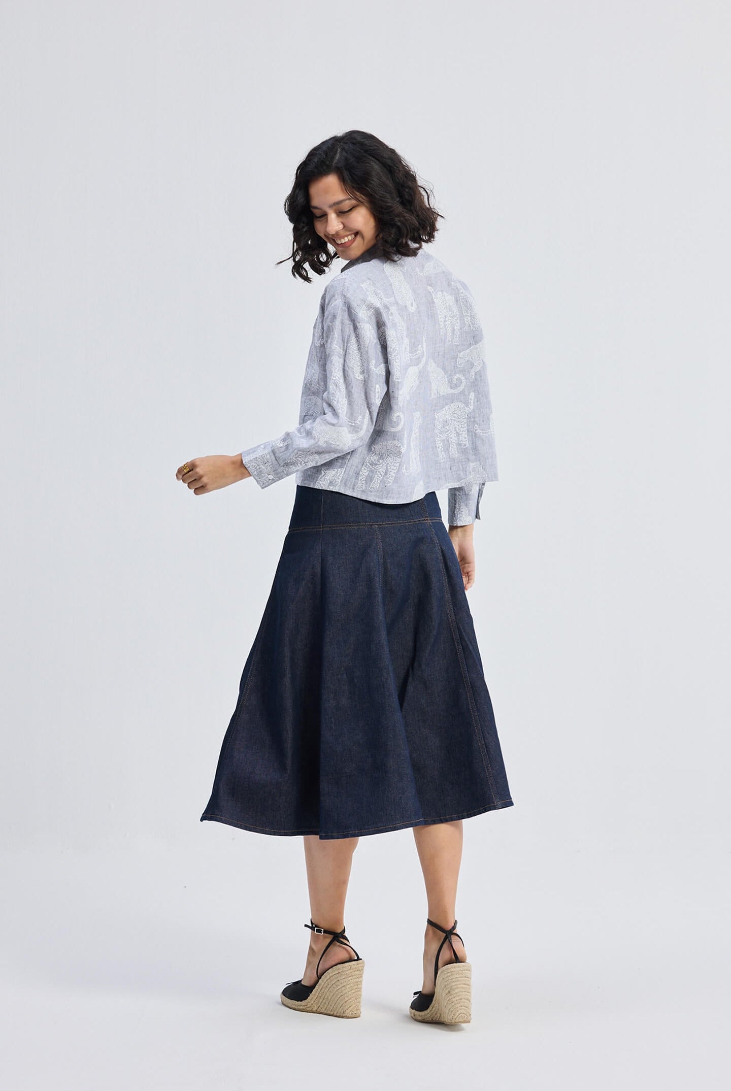 reistor Oversized Boxy-fit Shirt in Animal Print, back view on model styled with denim midi skirt and wedge heels