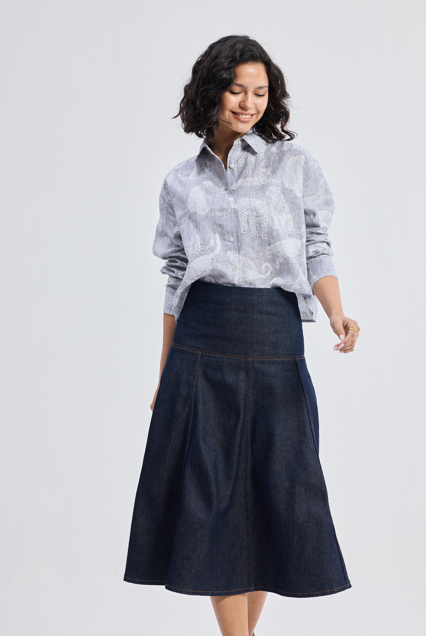 reistor Oversized Boxy-fit Shirt in Animal Print, model walking pose styled with denim midi skirt and wedge sandals