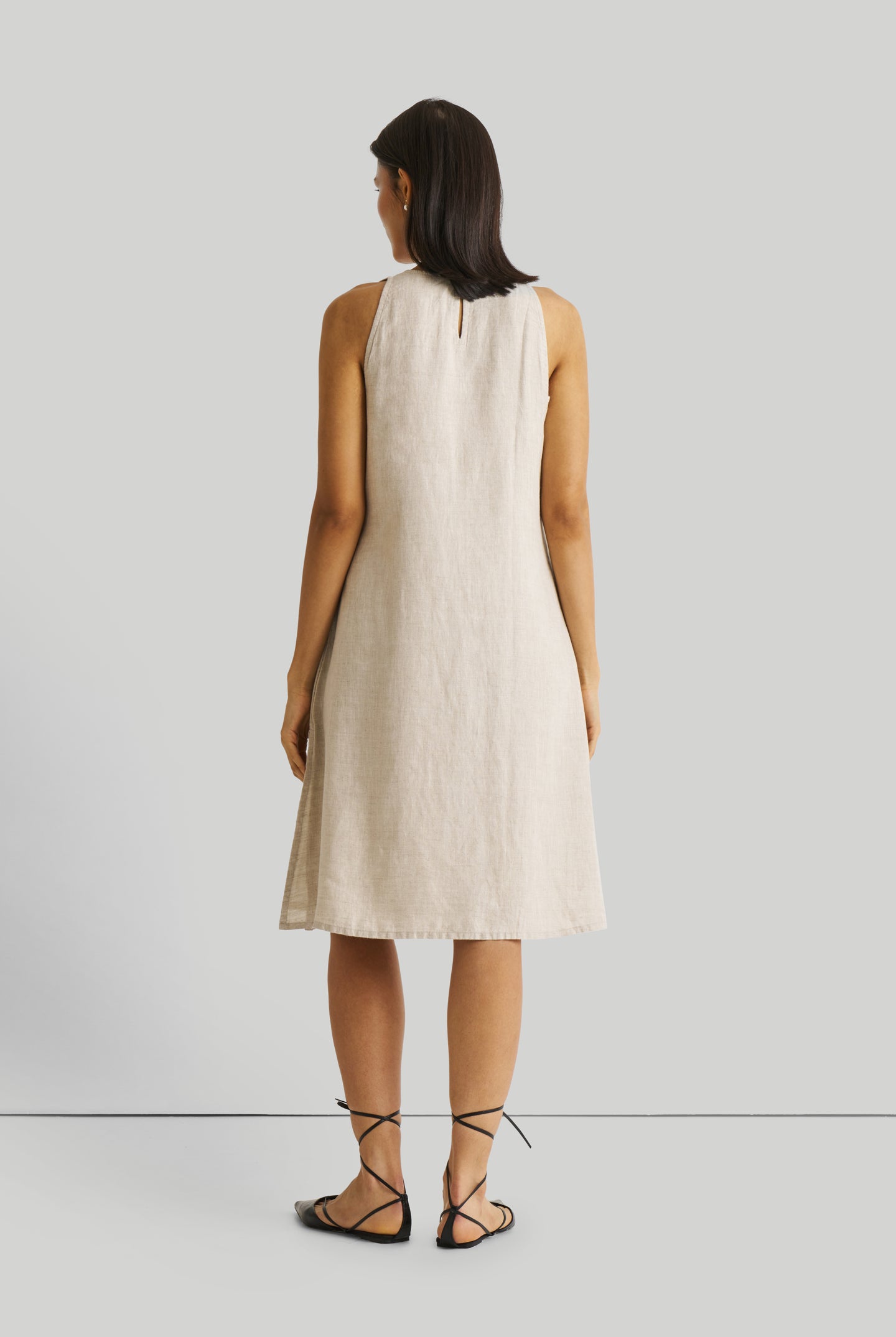 Reistor Reading Tea Leaves Dress in Ecru, sustainable sleeveless midi dress with a relaxed A-line silhouette, breathable fabric, and elegant back view.