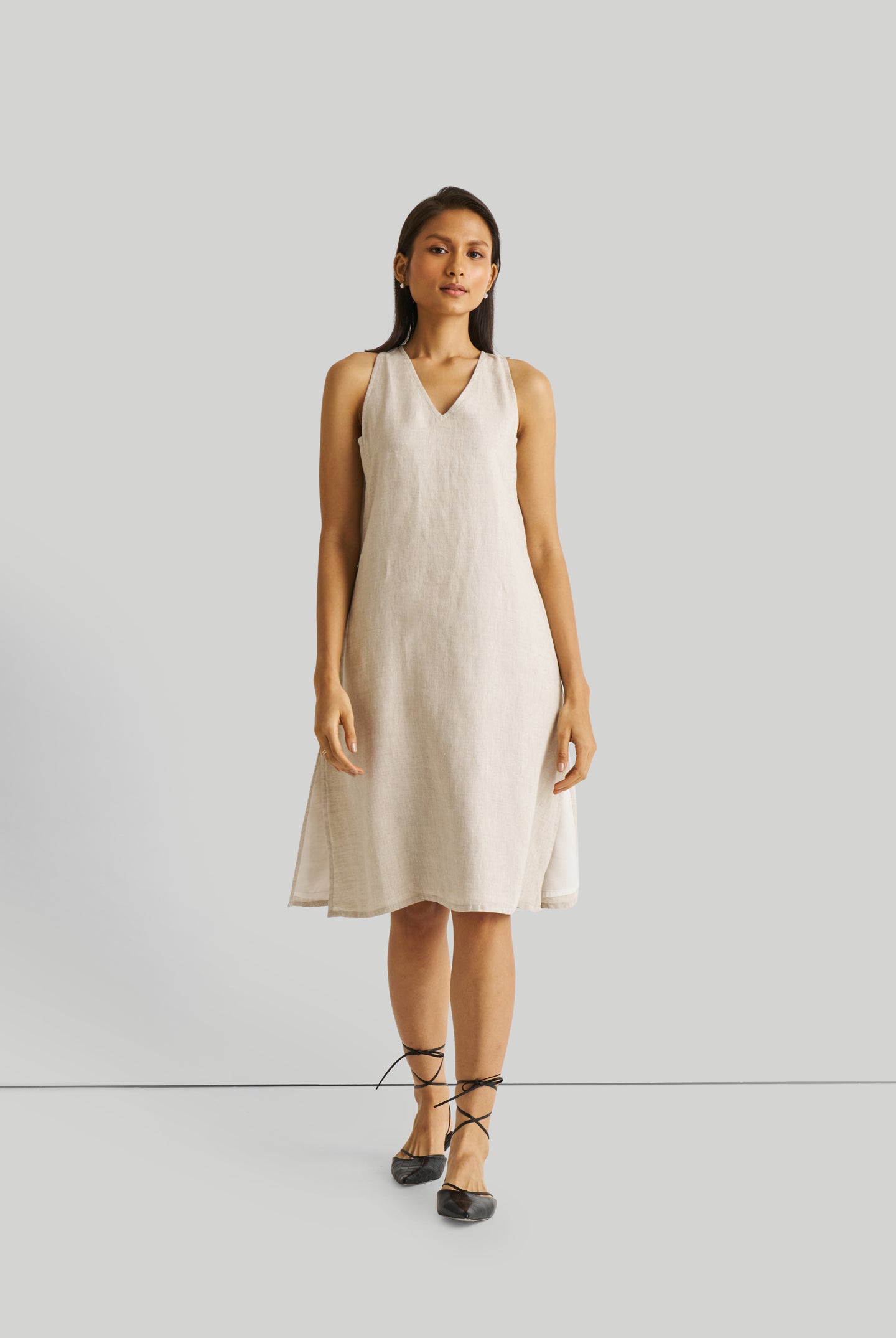 Reistor Reading Tea Leaves Dress in Ecru, sustainable sleeveless V-neck midi dress with a relaxed A-line fit, breathable fabric, and timeless style.