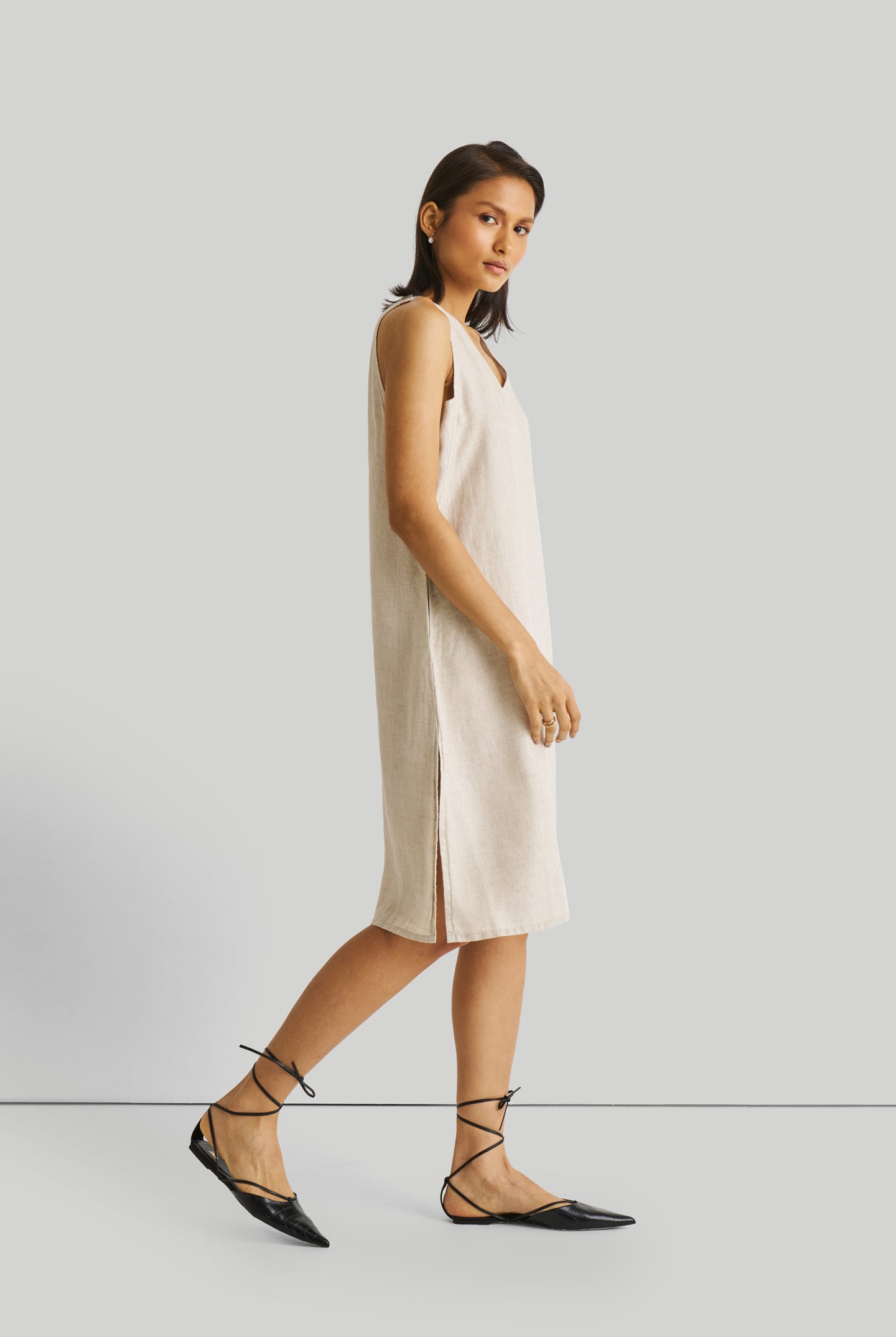 Reistor Reading Tea Leaves Dress in Ecru, sustainable sleeveless V-neck midi dress with side slits, breathable fabric, relaxed fit, and timeless style.