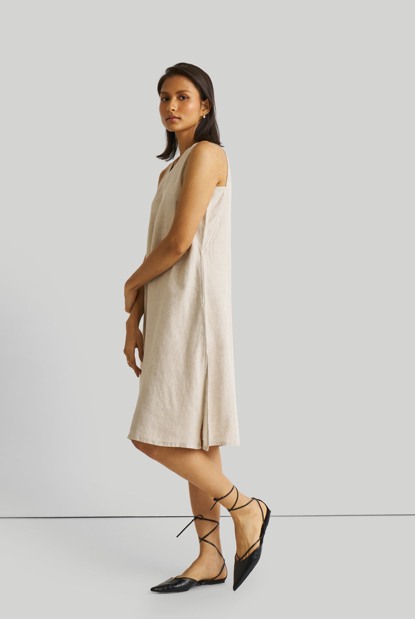 Reistor Reading Tea Leaves Dress in Ecru, sustainable sleeveless V-neck midi dress with side slits, breathable fabric, relaxed fit, and elegant style.