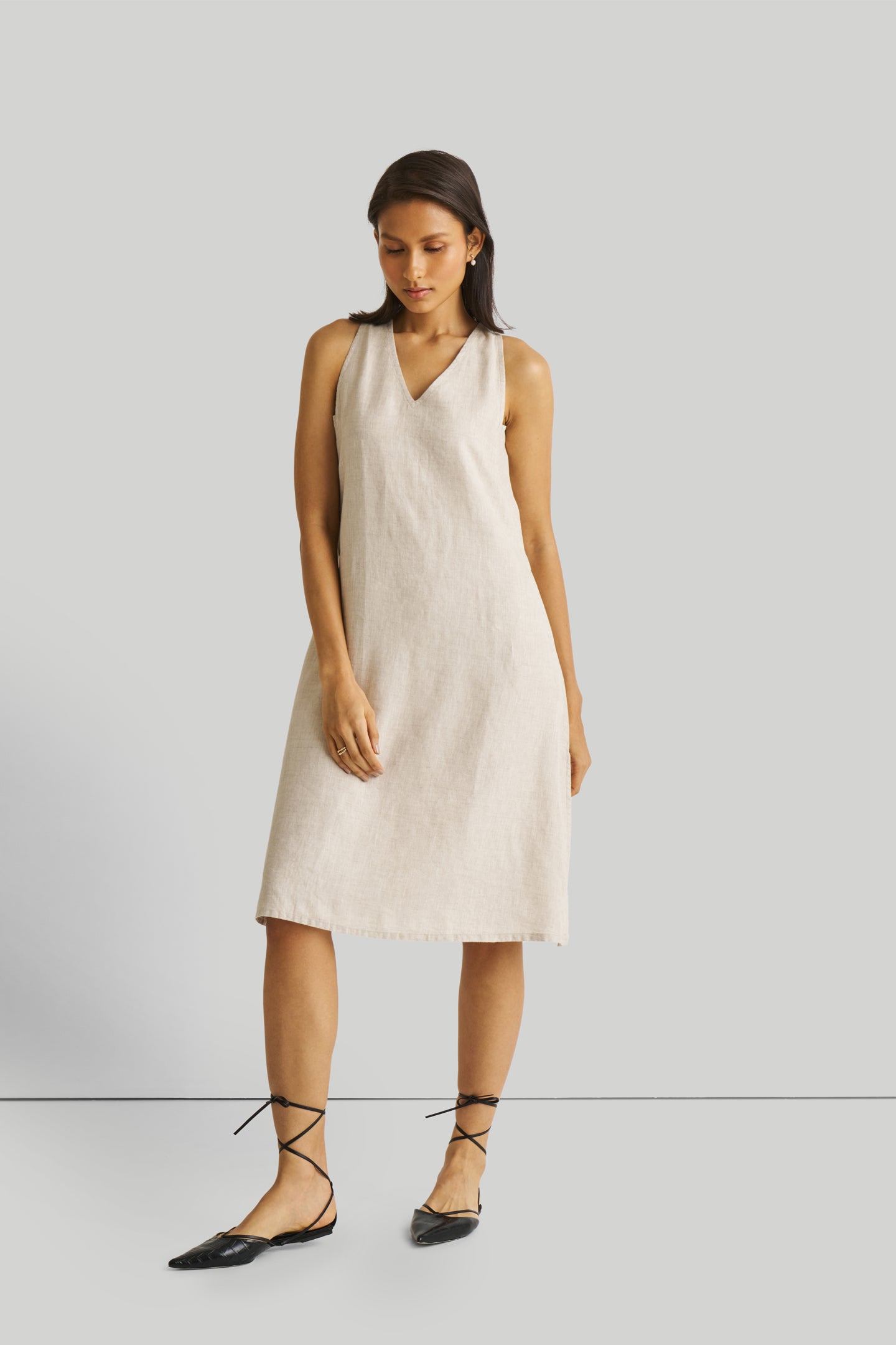 Reistor Reading Tea Leaves Dress in Ecru, sustainable sleeveless V-neck midi dress with a relaxed A-line fit, breathable fabric, and effortless style.