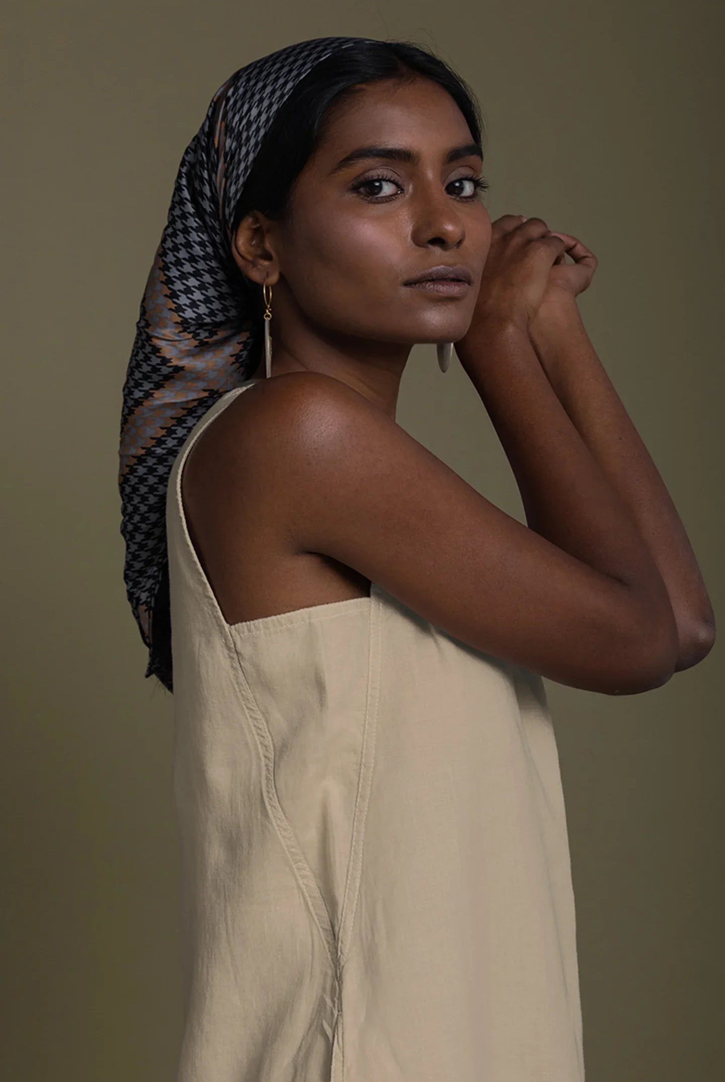 Close-up of Reistor Reading Tea Leaves Dress in Neutral Beige, sleeveless V-neck midi dress with relaxed fit.