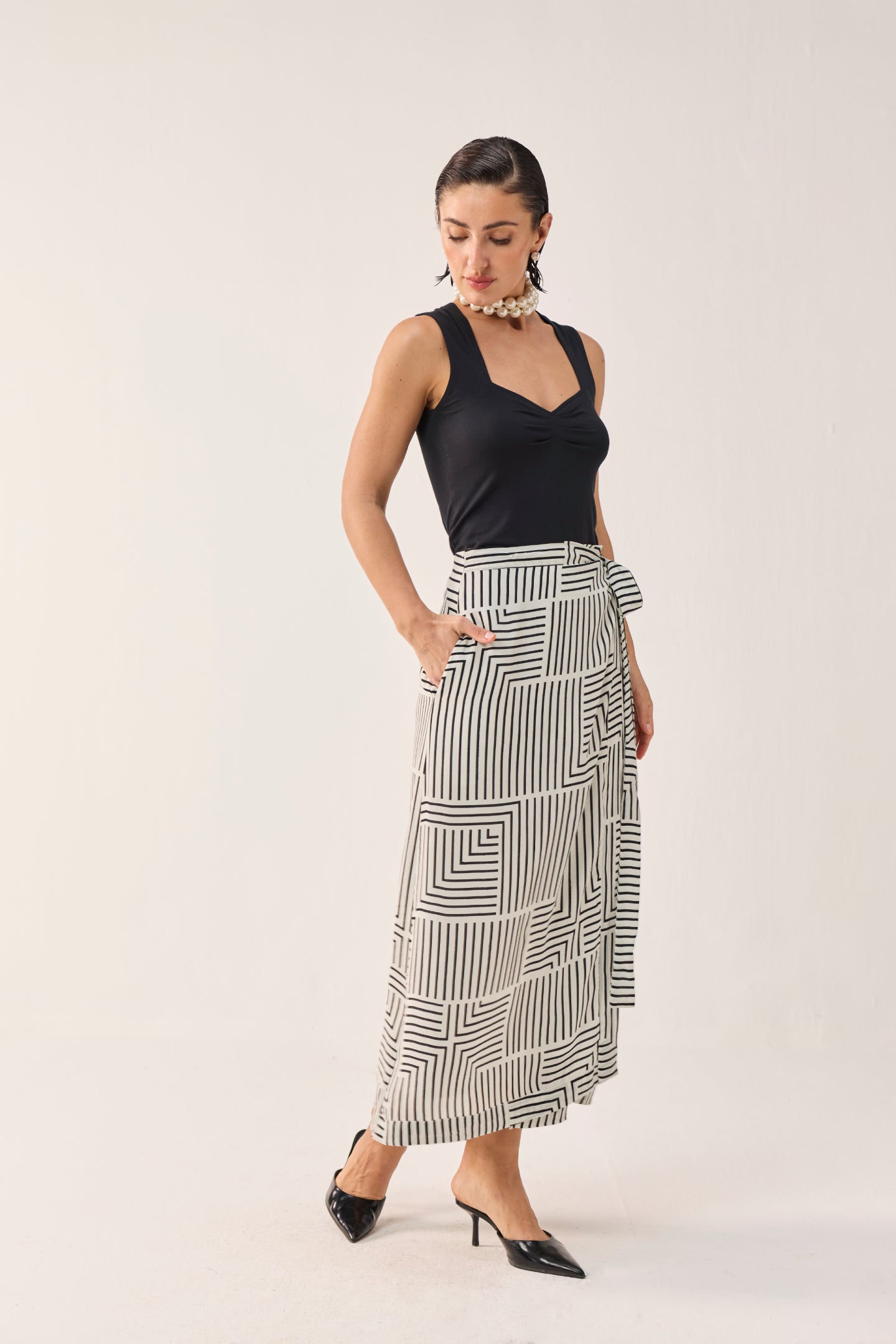 Reistor Regular Sweetheart Neck Top in Black with a black and white printed wrap skirt.
