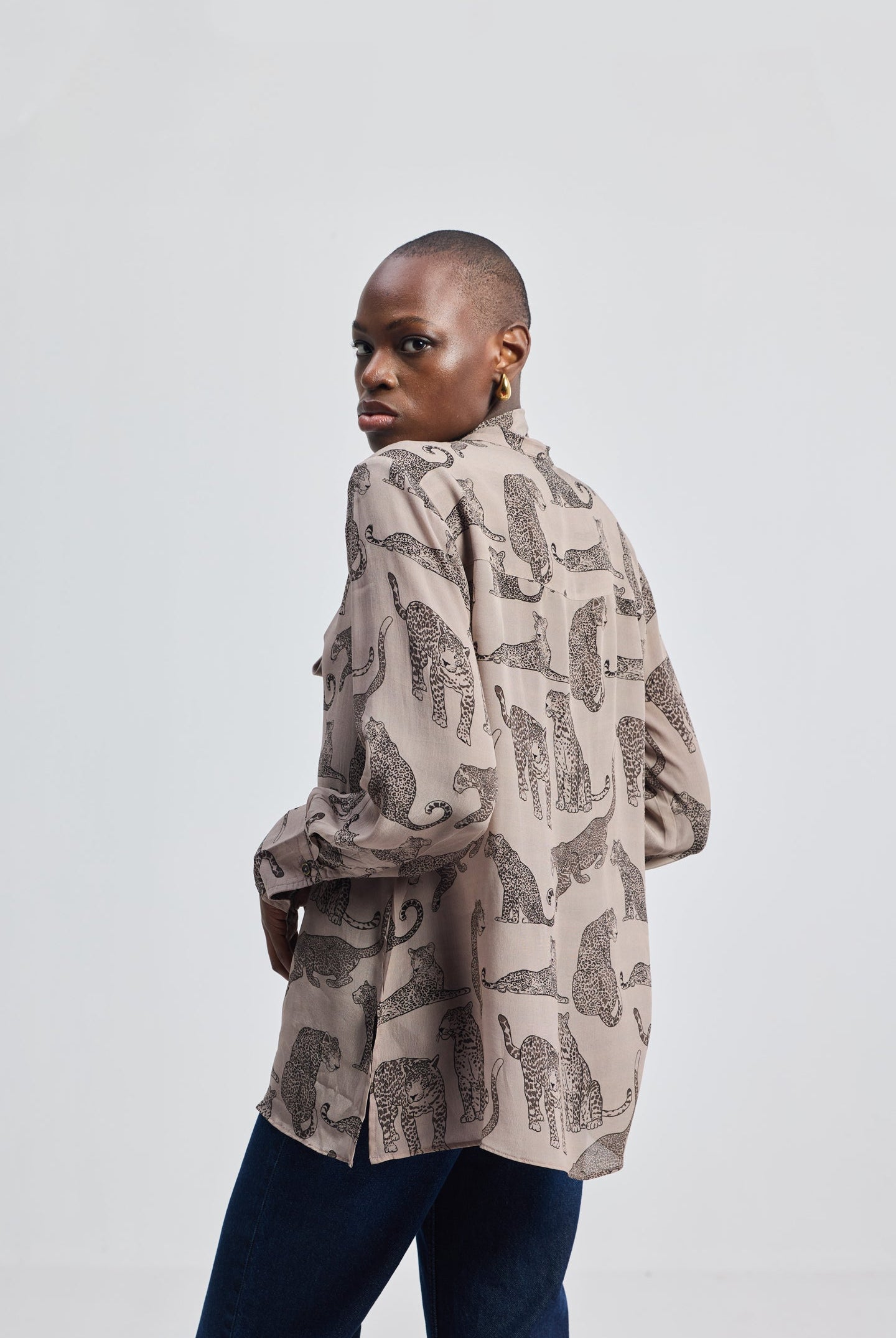 Sustainable fashion: Reistor Relaxed-Fit Top with Front-tie in Animal Print featuring a front neck tie detail and long sleeves.