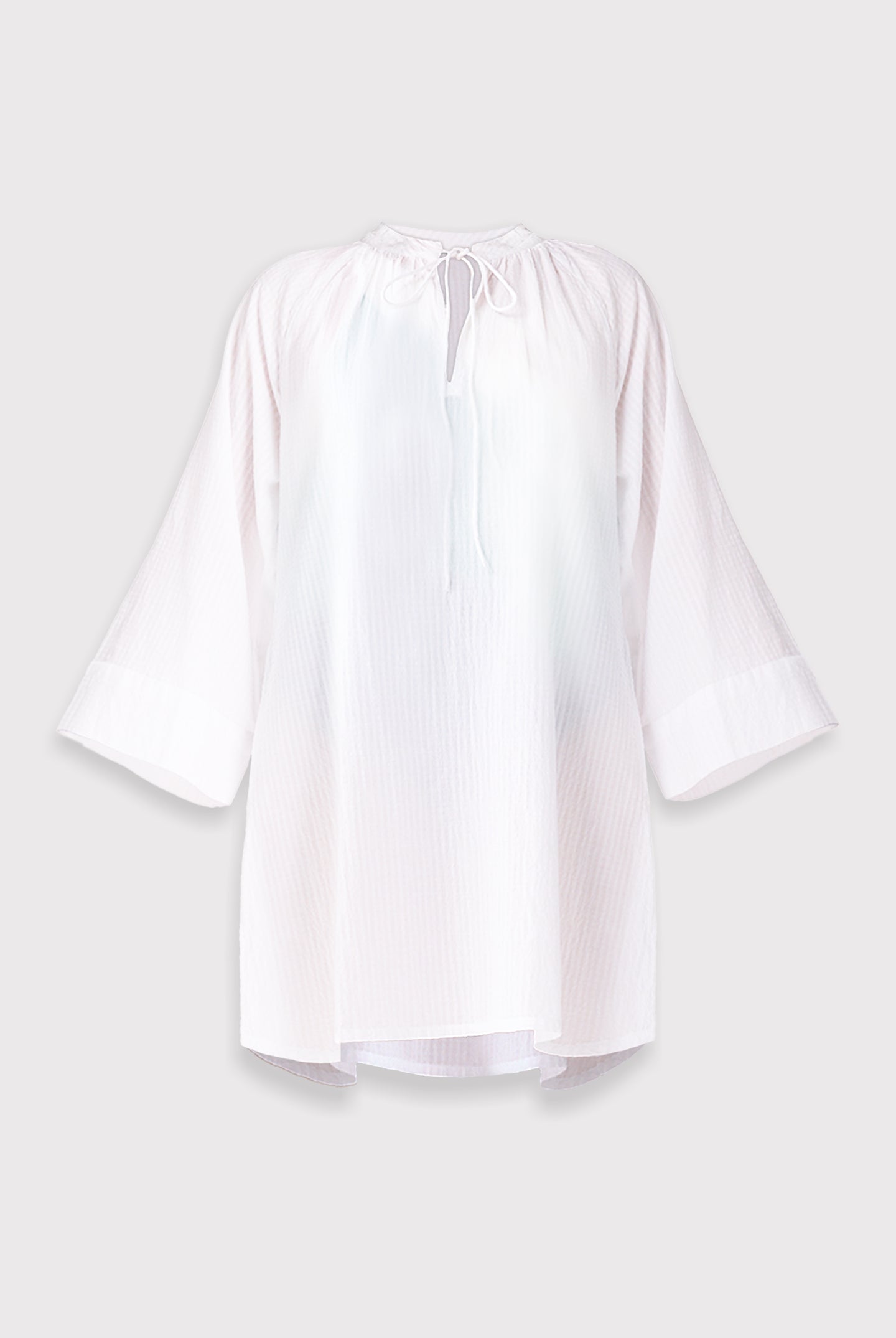 White beach cover-up with bell sleeves on a light gray background