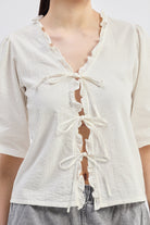 Relaxed Fit Top With Ruffles and Front-Ties in Cream Closeup