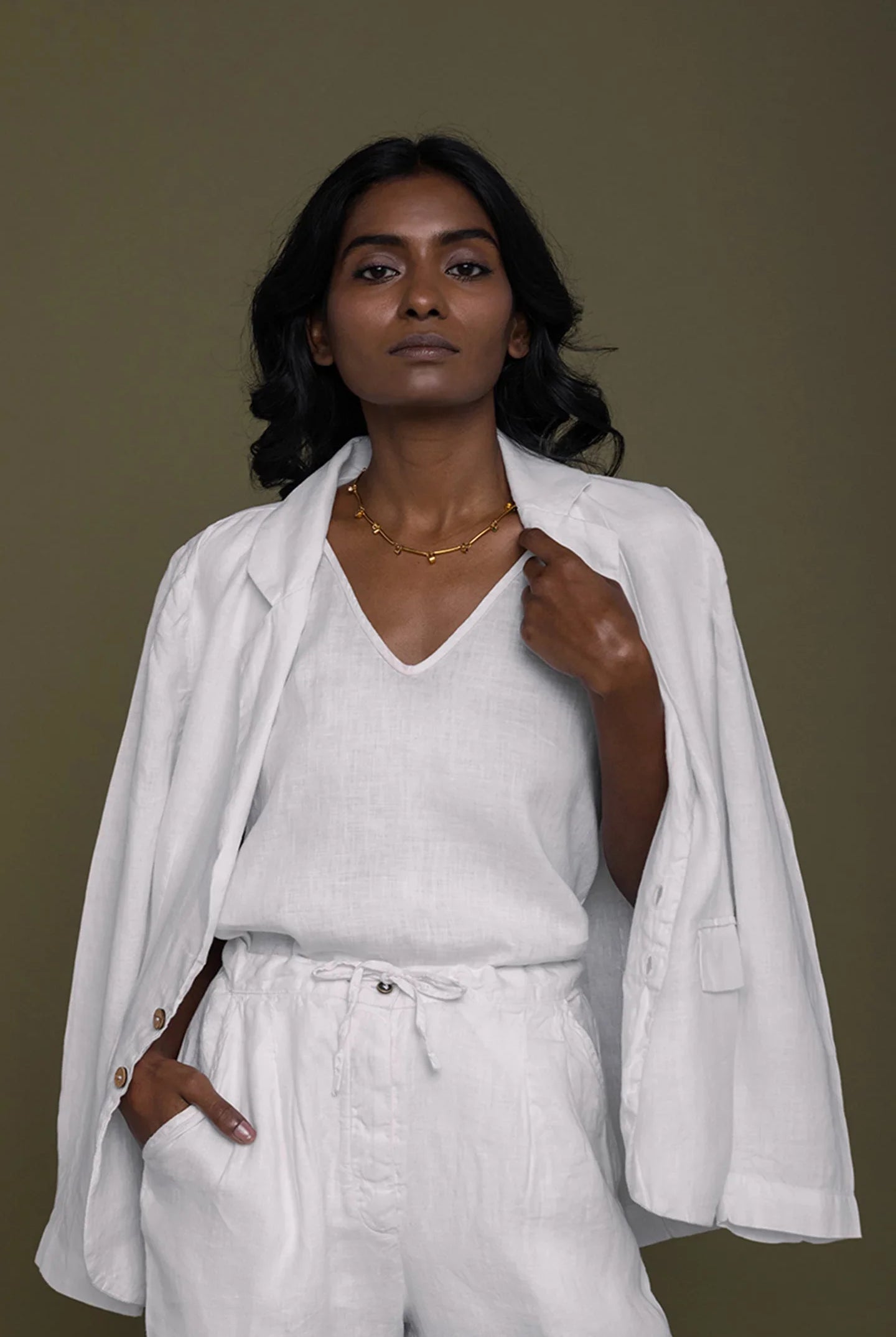 Reistor She's Everything Blazer in White layered over a white V-neck top with relaxed pants, sustainable women's fashion.