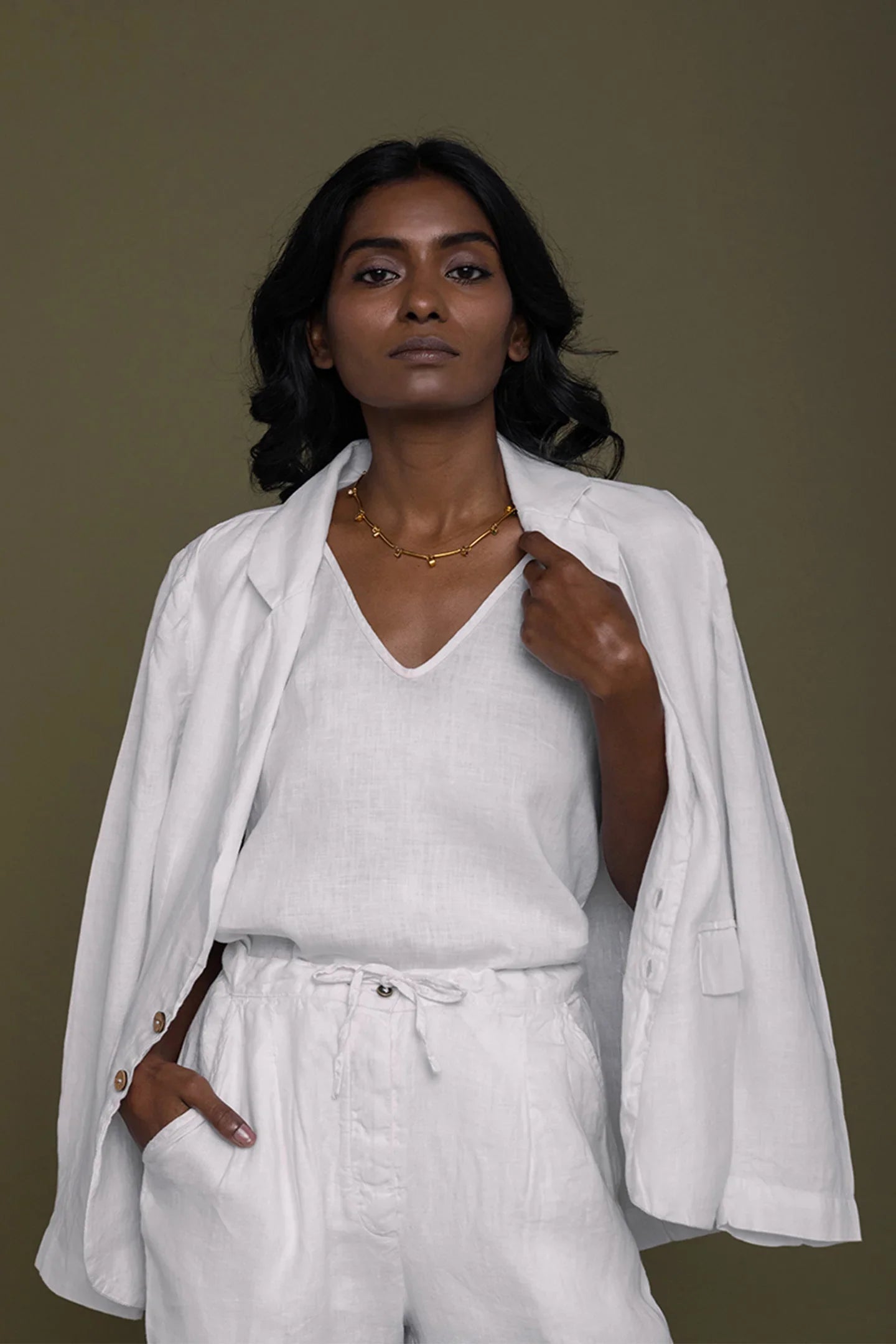 Reistor She's Everything Blazer in White layered over a white V-neck top with relaxed pants, sustainable women's fashion.