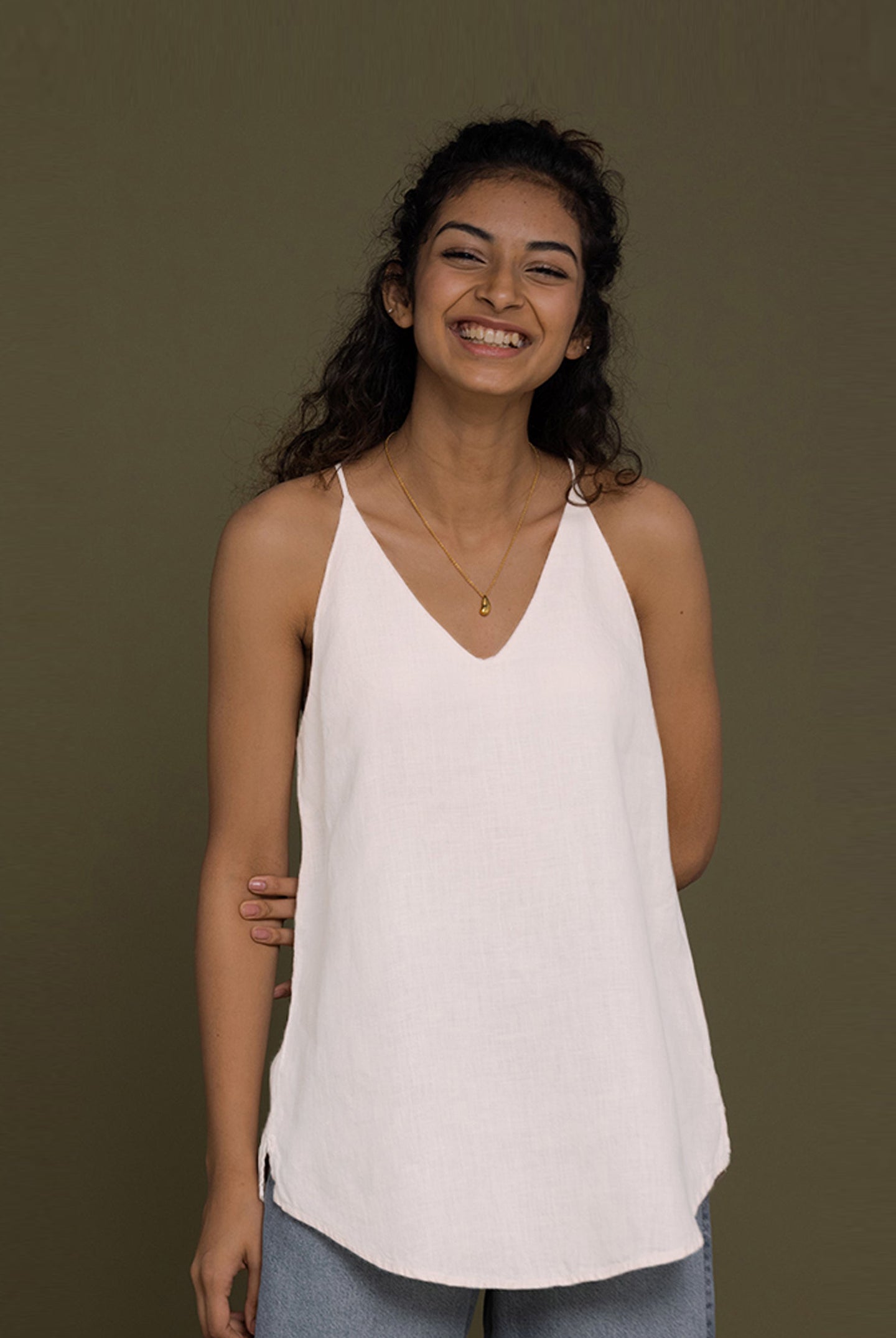 The Endless Sunday Top in White by Reistor, a lightweight sleeveless women's top with a relaxed fit, breathable fabric, minimalist style, and everyday comfort.