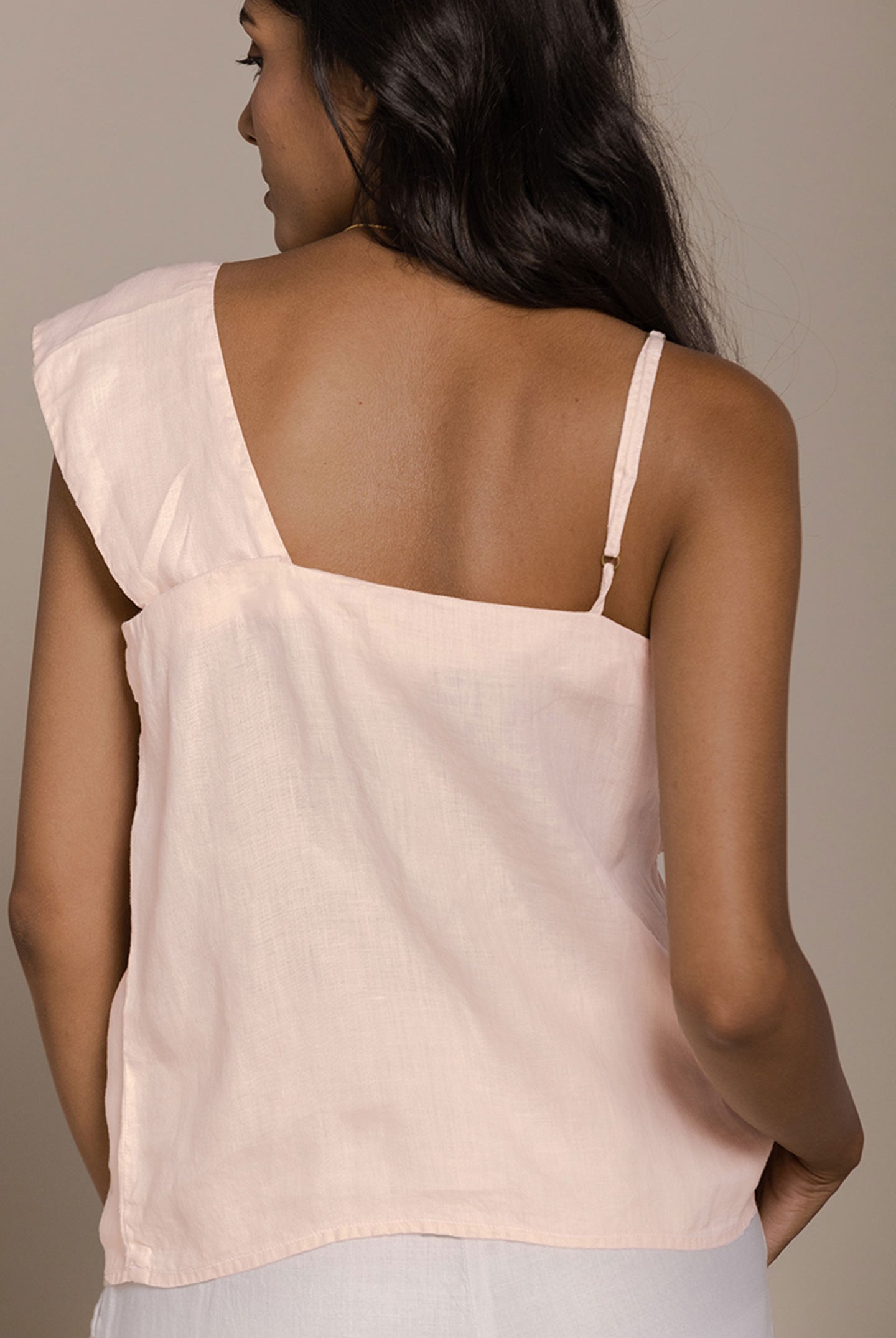 Reistor The Wandering Wave Top in Ice Pink features an elegant back view with an asymmetrical silhouette and airy drape.