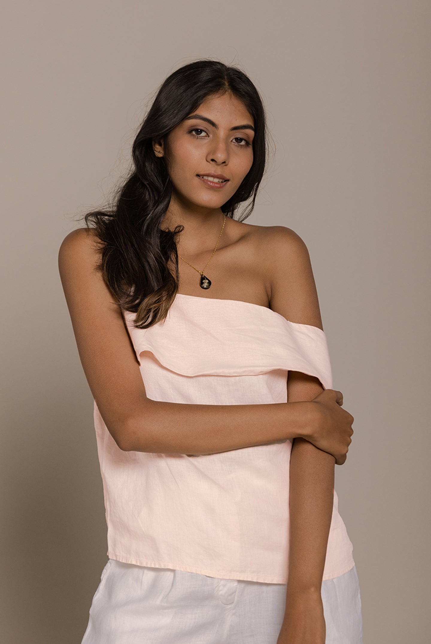 Reistor The Wandering Wave Top in Ice Pink showcases an off-shoulder neckline with a soft, breezy silhouette.