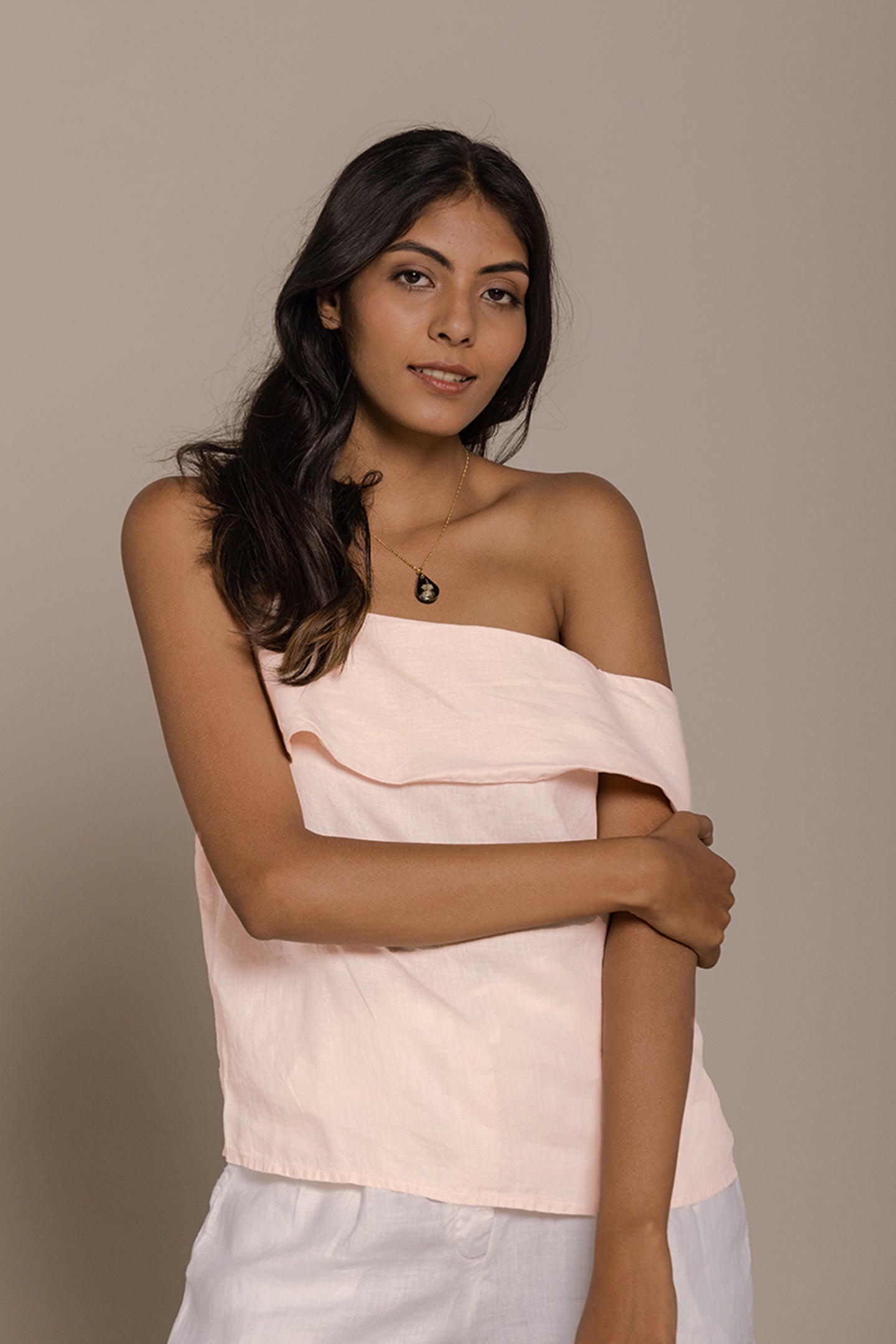 Reistor The Wandering Wave Top in Ice Pink showcases an off-shoulder neckline with a soft, breezy silhouette.