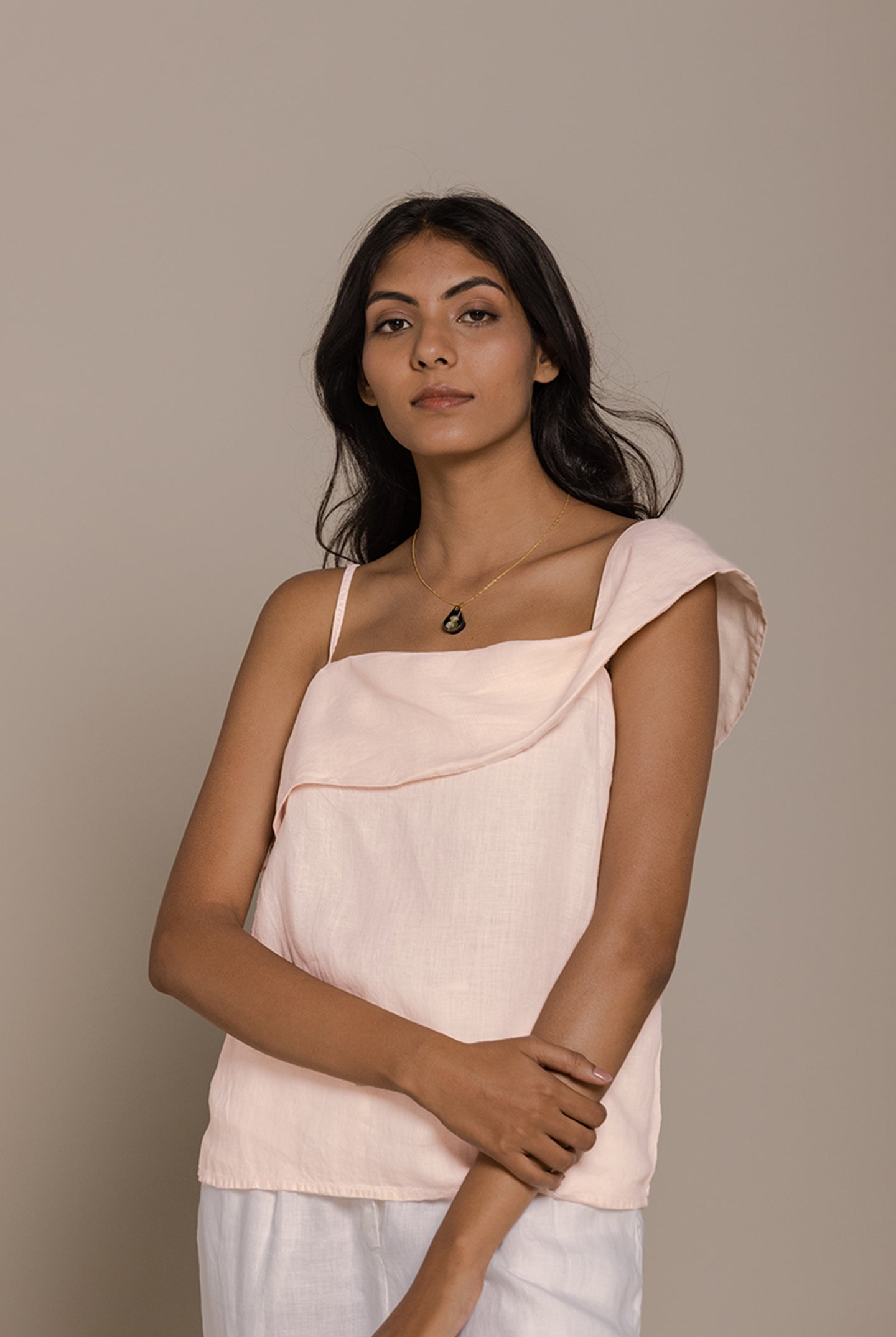 Reistor The Wandering Wave Top in Ice Pink features a graceful asymmetric neckline and relaxed fit design.