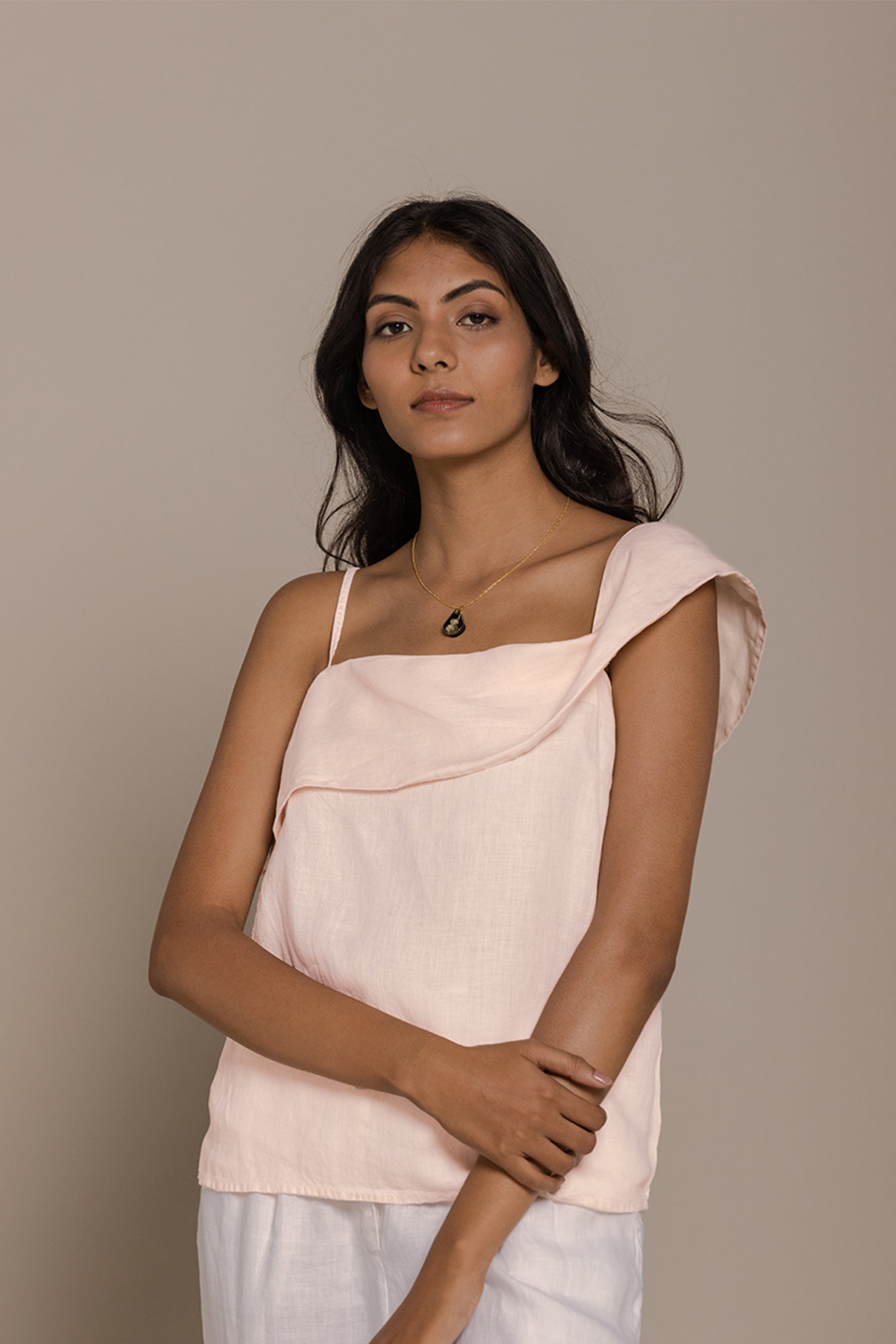 Reistor The Wandering Wave Top in Ice Pink features a graceful asymmetric neckline and relaxed fit design.