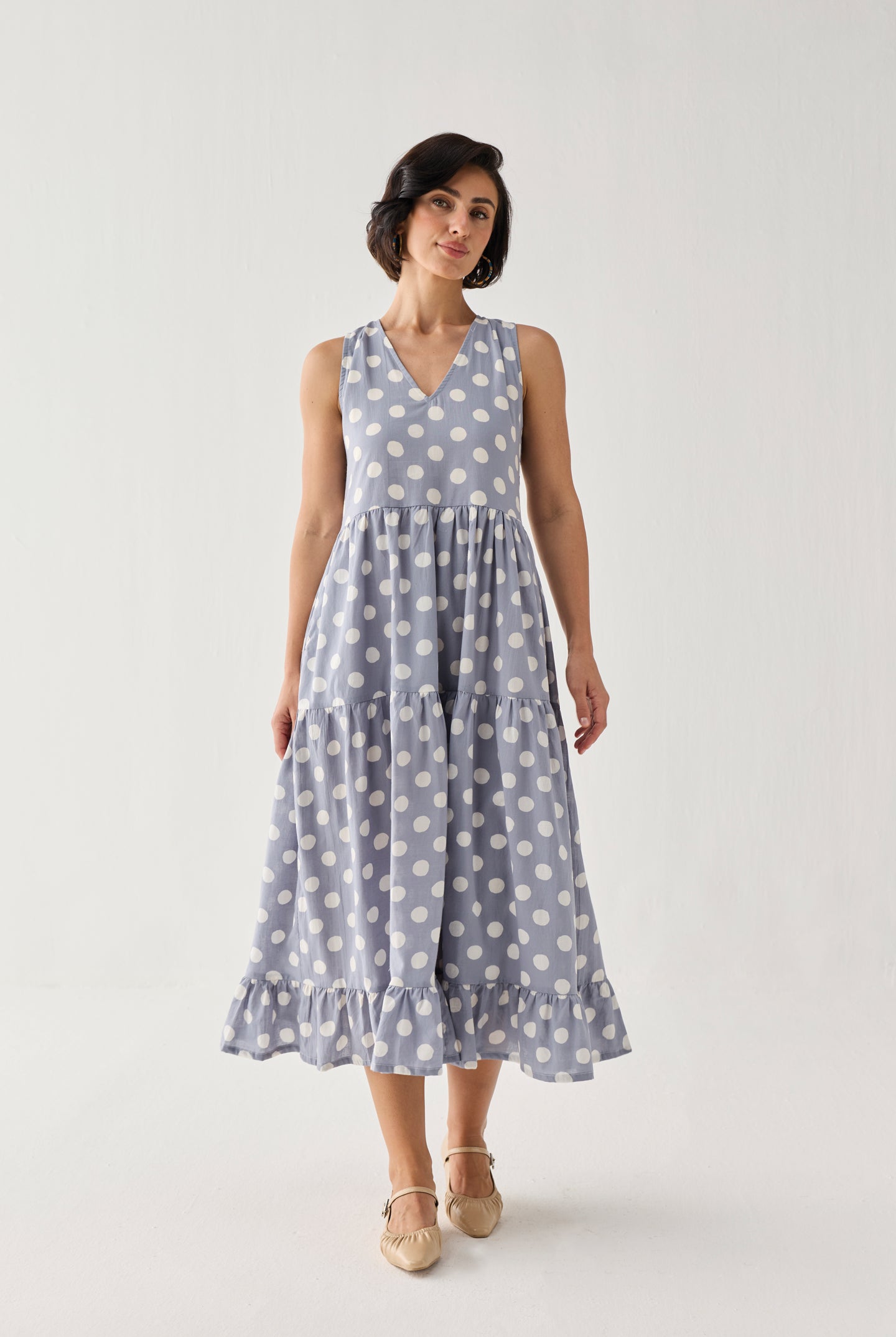 Tiered Midi Dress in Blue Polka featuring a softly flared silhouette, playful oversized dot print, and a fluttering hem that adds movement and charm.
