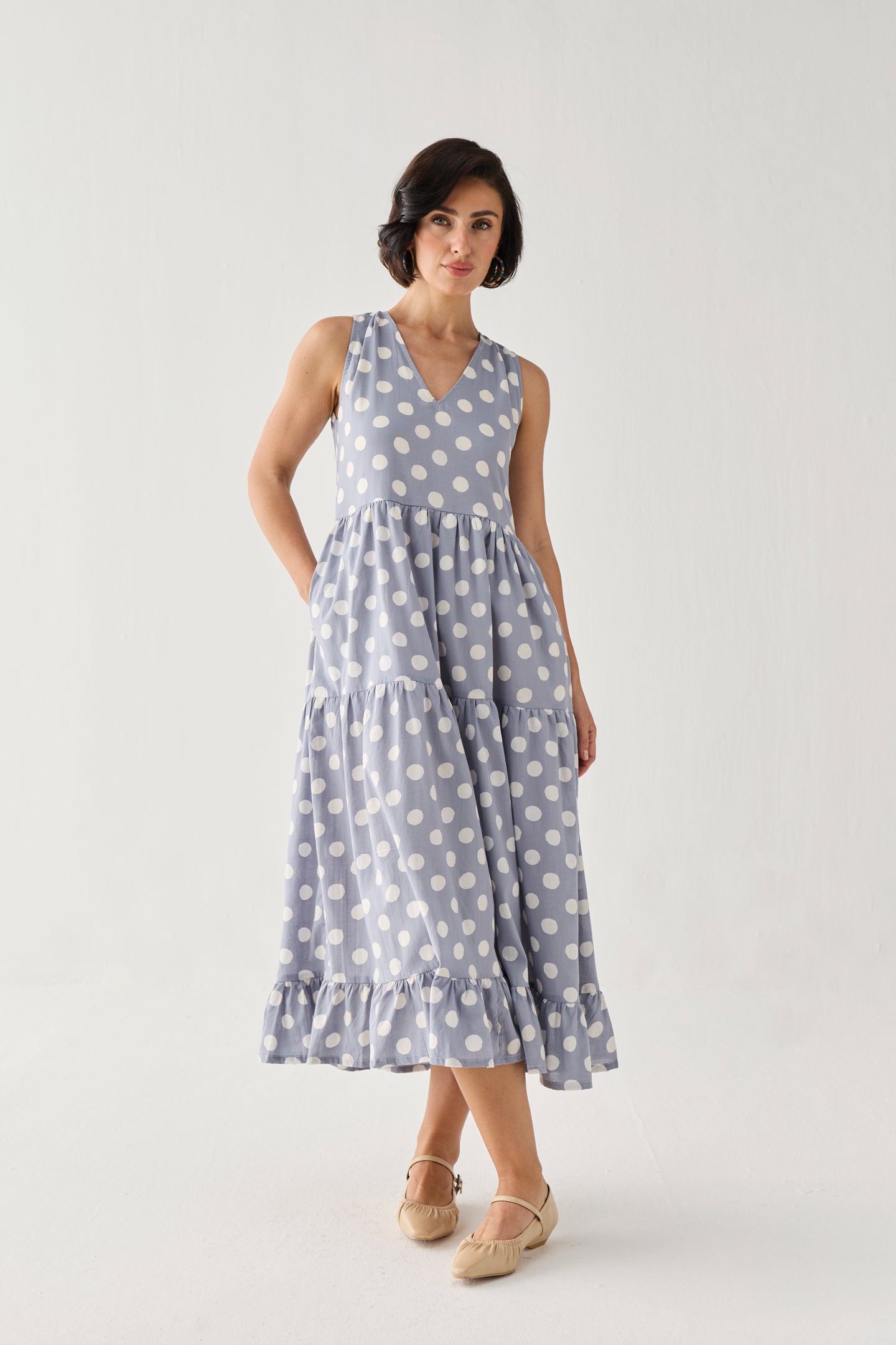 Tiered Midi Dress in Blue Polka with a softly gathered waist, oversized white dot print, and flowing layered skirt, styled in a relaxed full-length pose.