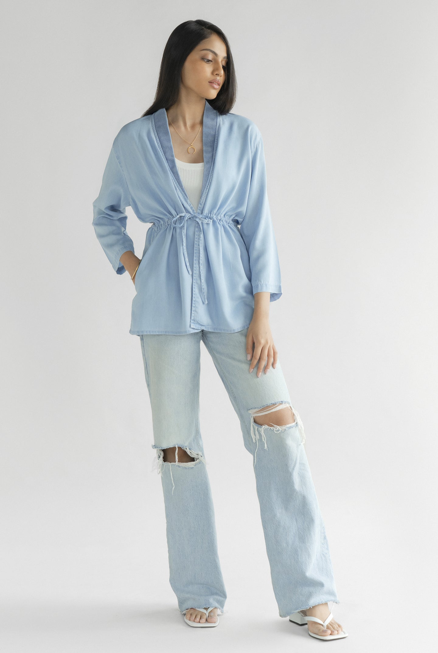 Full-length view of the Reistor Travel Light Denim Jacket in Ocean Blue, featuring a drawstring waist, lightweight denim fabric and relaxed everyday style.