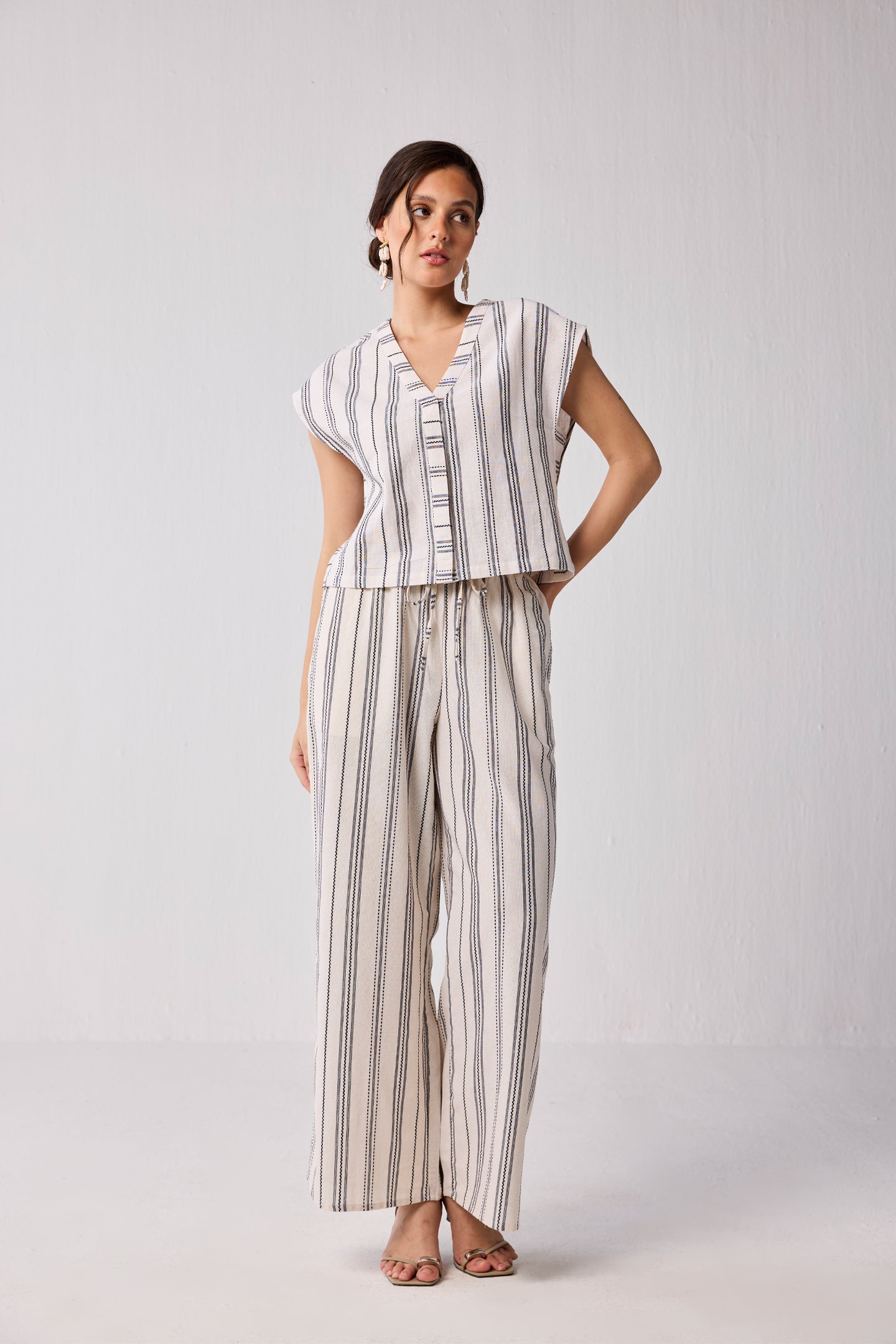 Model wearing Reistor Wide-leg Drawstring Pants in Stripes with a matching striped top, featuring a relaxed fit and breathable fabric.