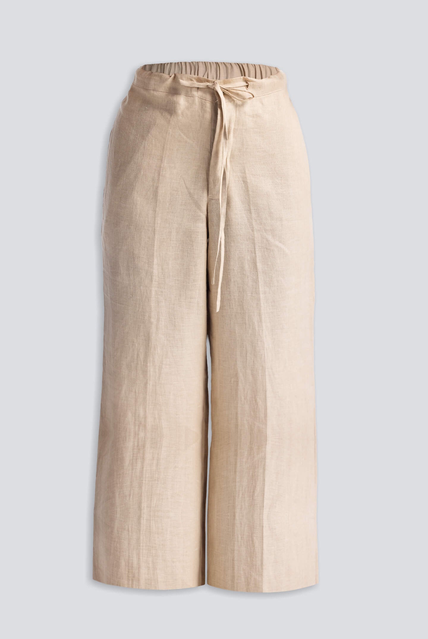 Close-up of Reistor Wide Leg Pants in Hemp, highlighting the soft textured hemp fabric, adjustable drawstring waist, and relaxed sustainable design in a natural beige shade.