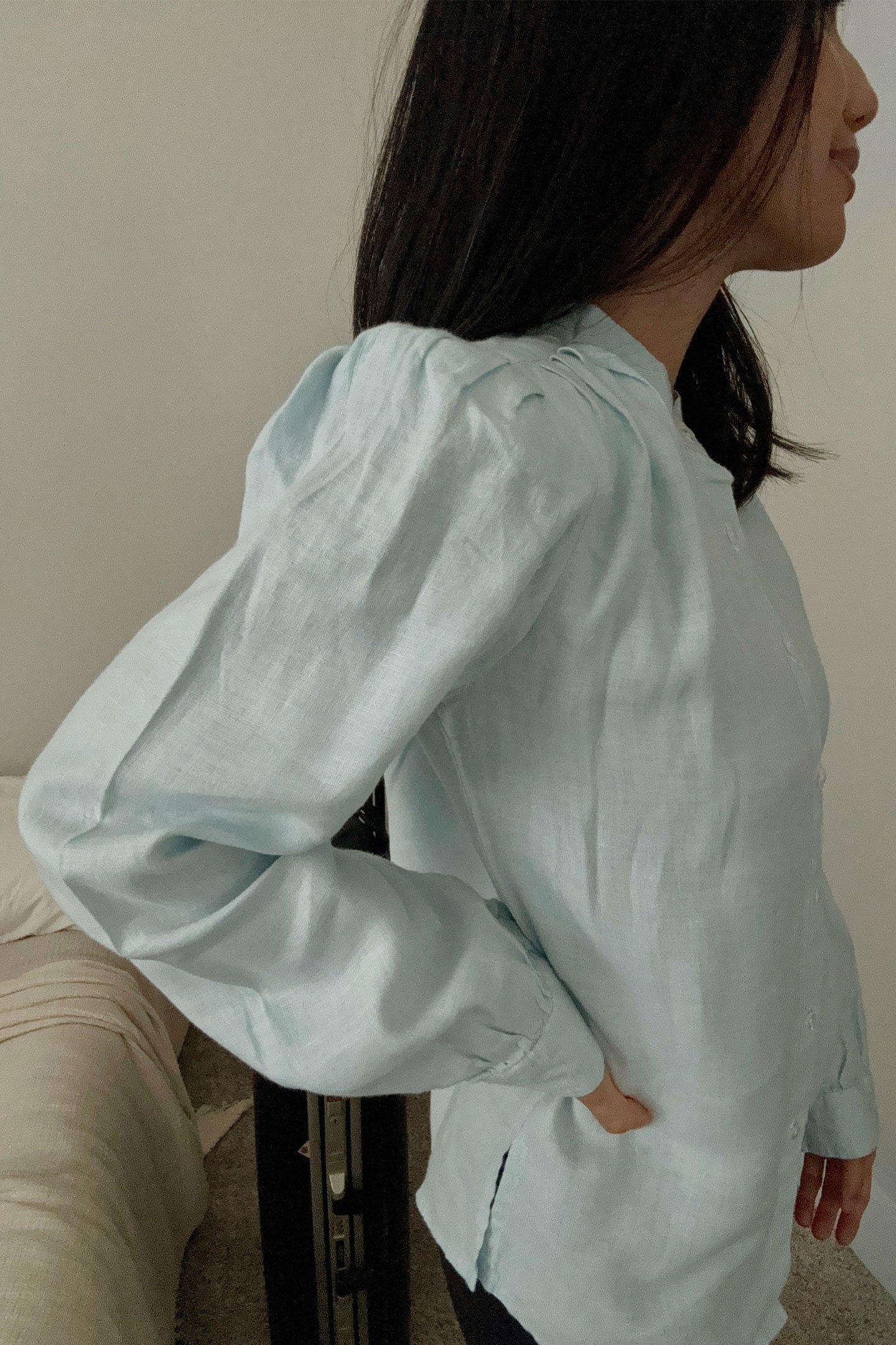Model wearing the Reistor Wild River Shirt in Blue from a side angle, showcasing its airy sustainable fabric, relaxed fit and refined minimalist design.