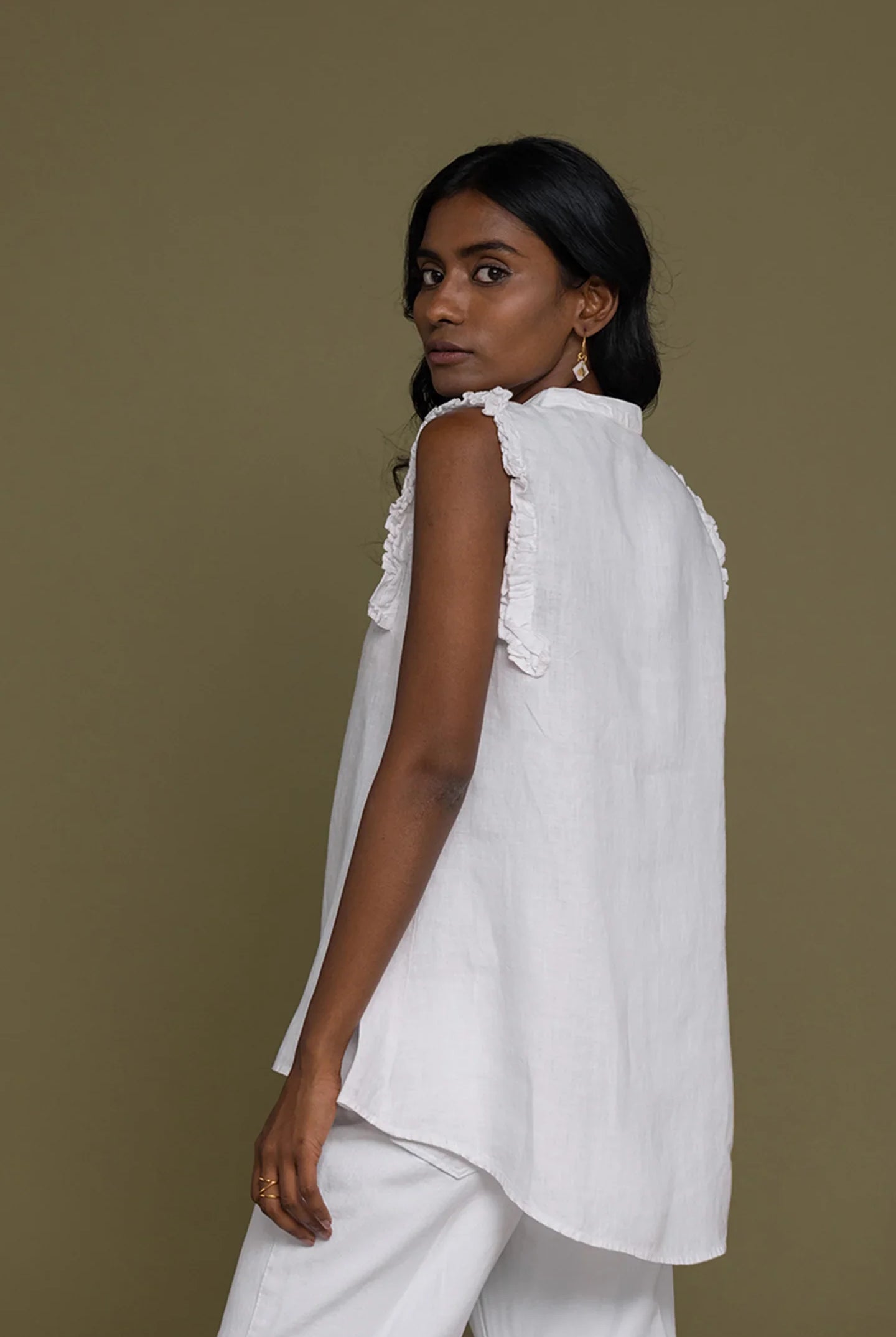 Reistor Wind in my Hair Shirt in White for women, angled back view with ruffle sleeves and a breezy relaxed fit