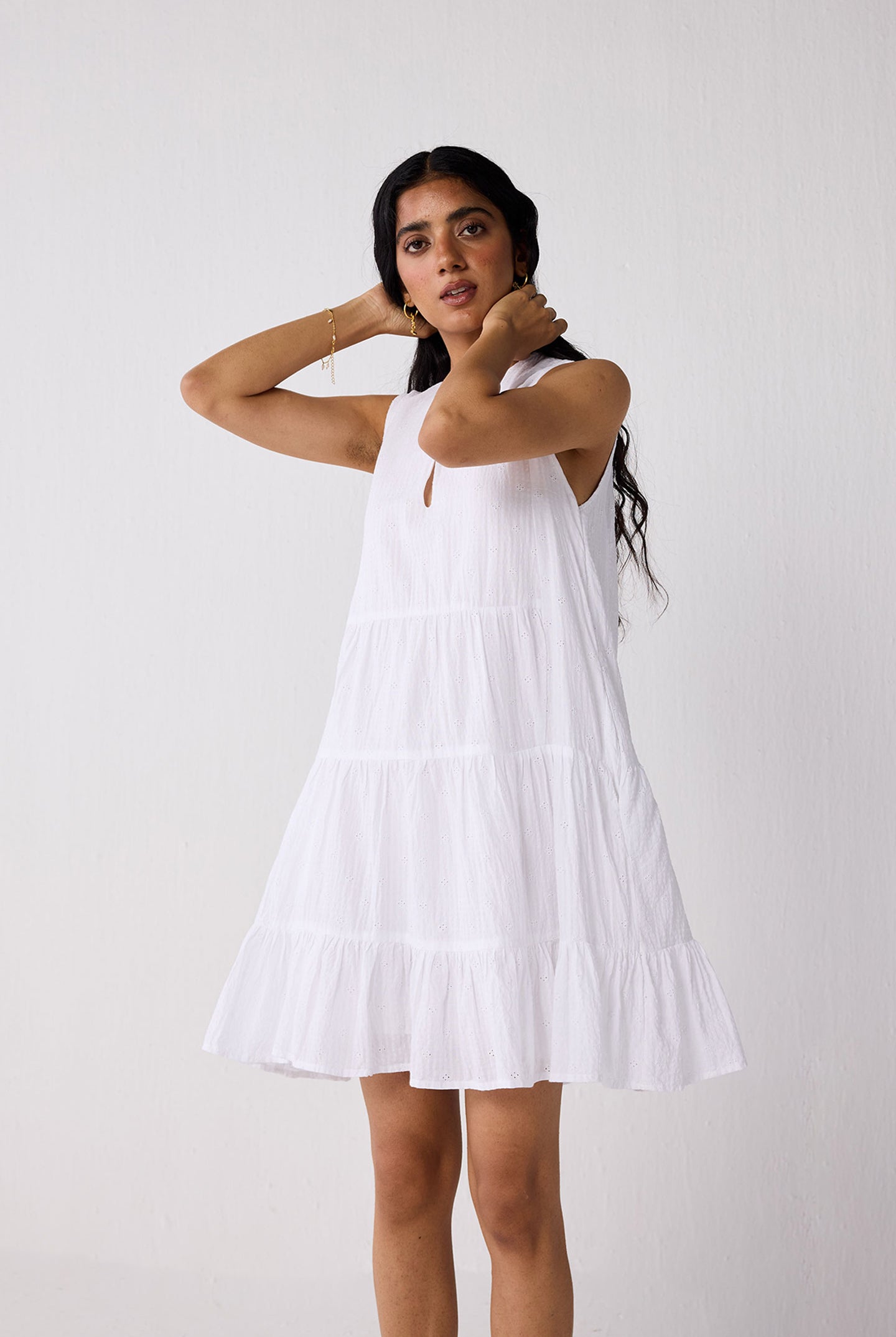 Woman wearing a white dress against a plain background