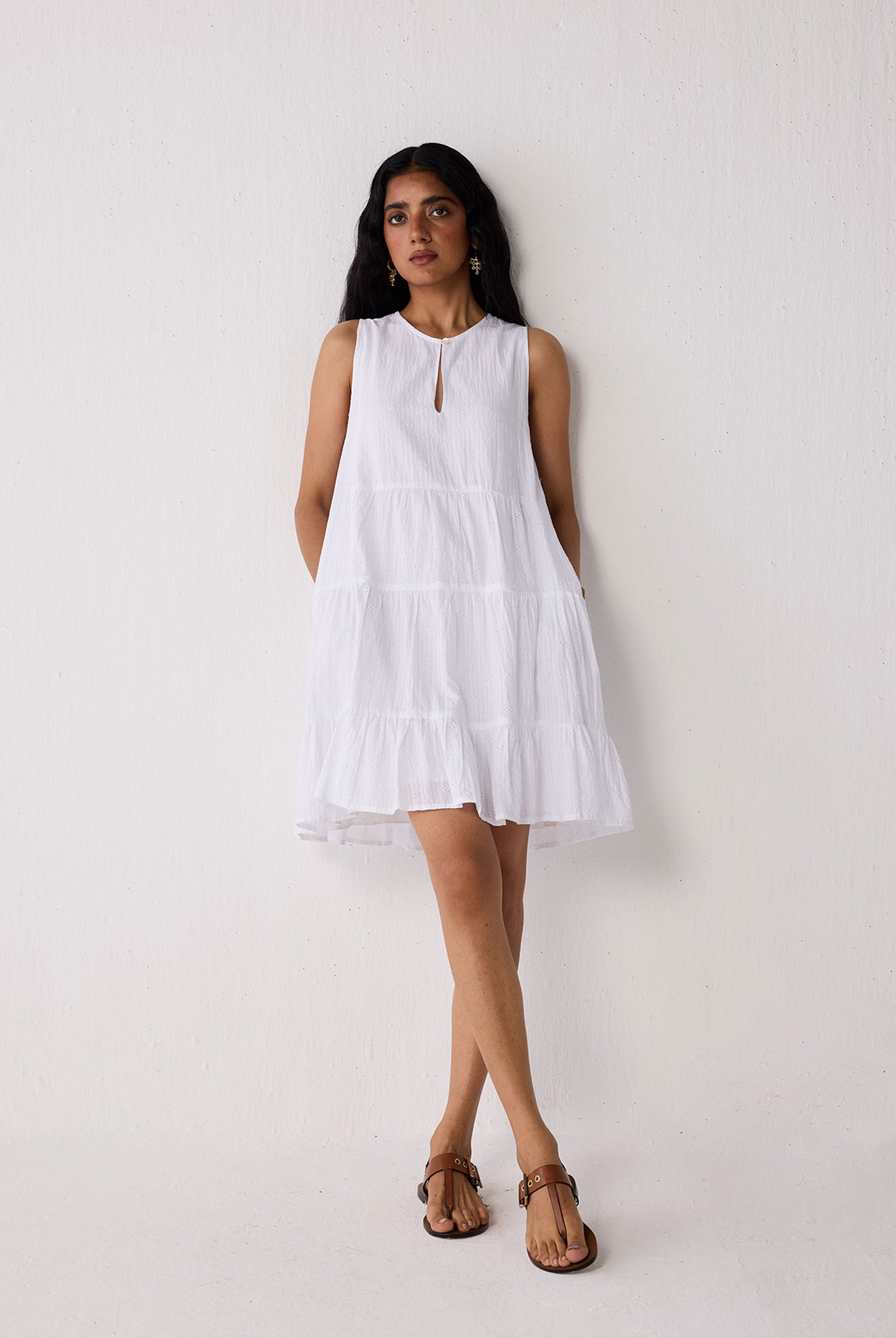 Woman wearing a white dress against a plain background