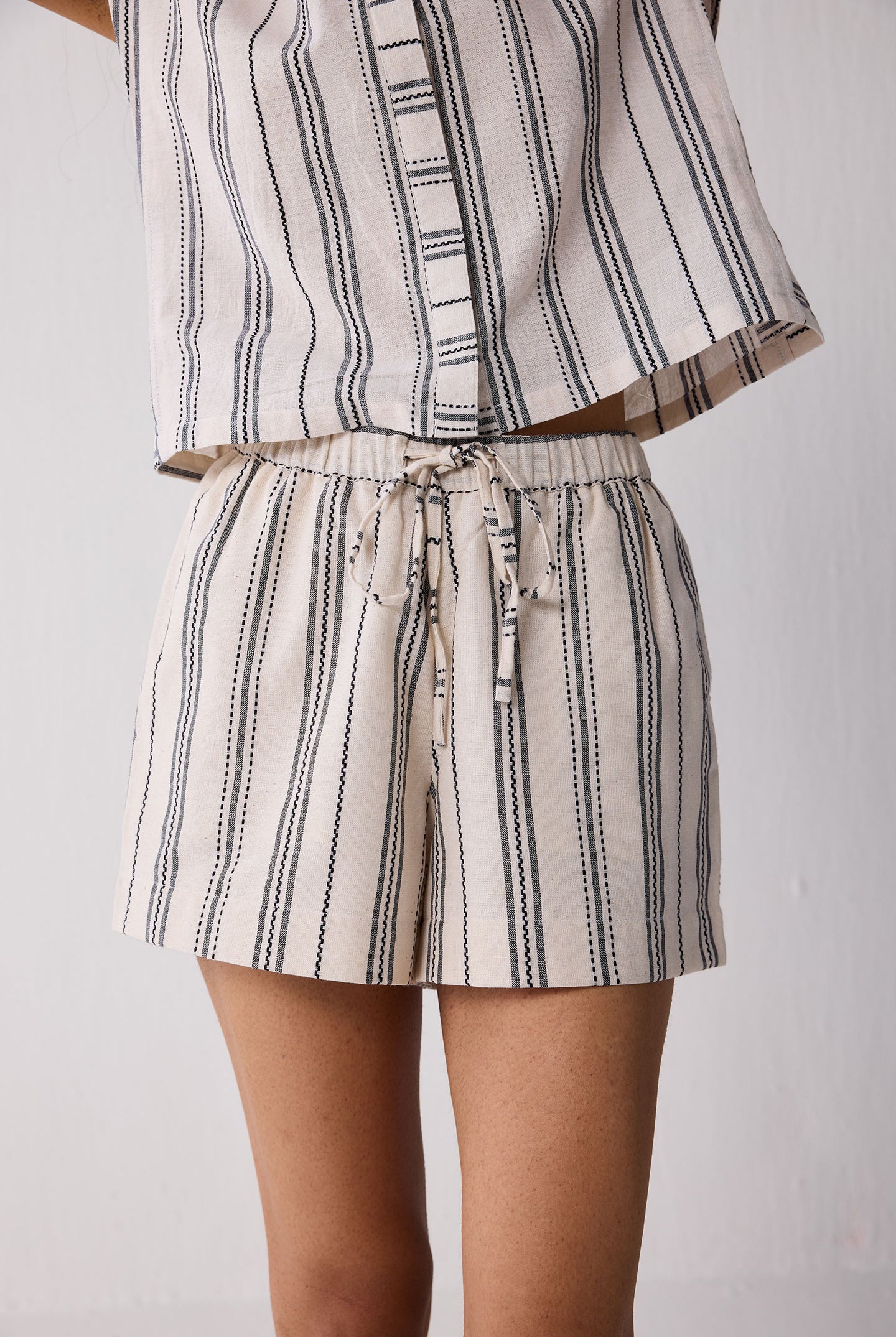Striped outfit with a top and shorts on a plain background
