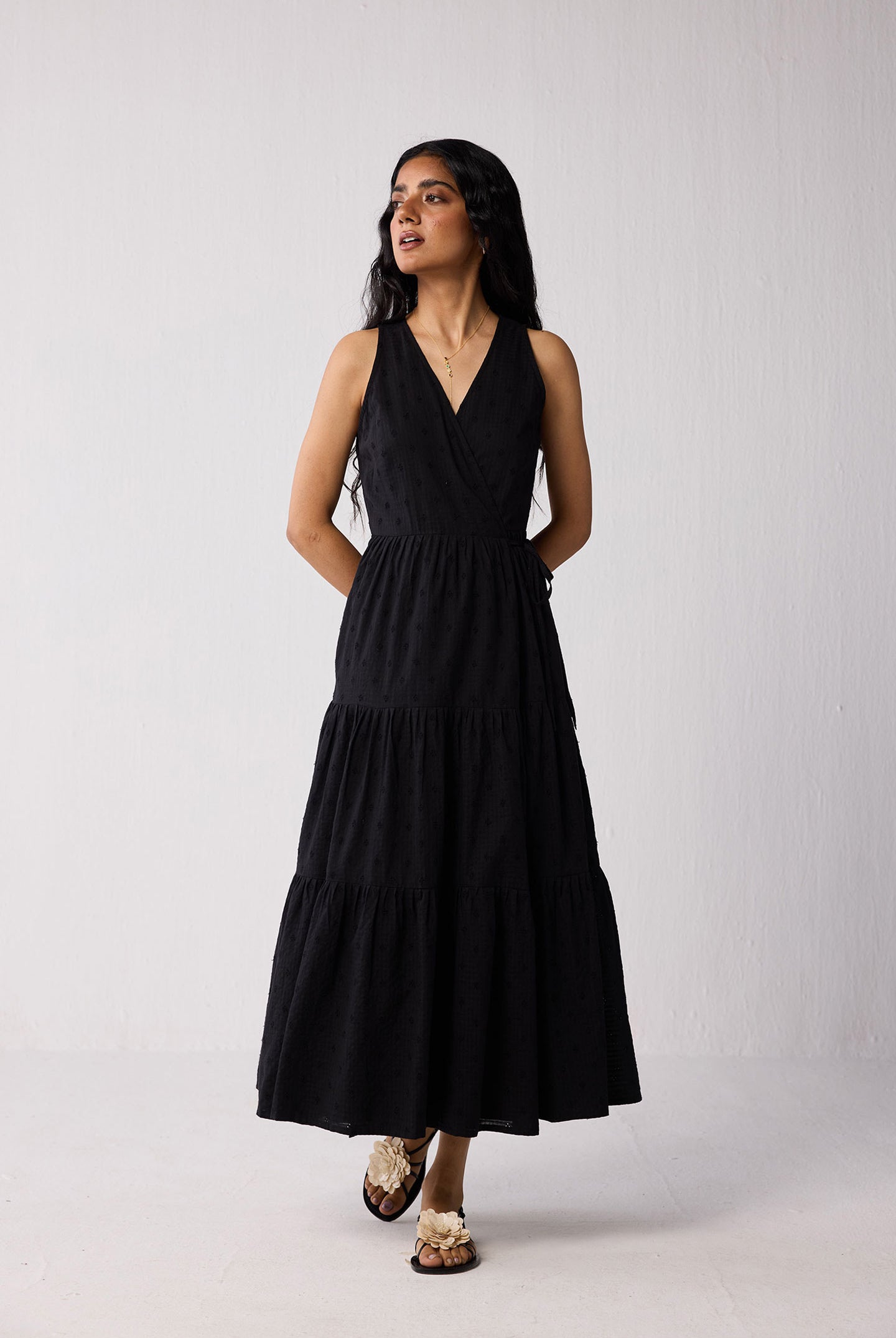 Woman wearing a black dress against a white background
