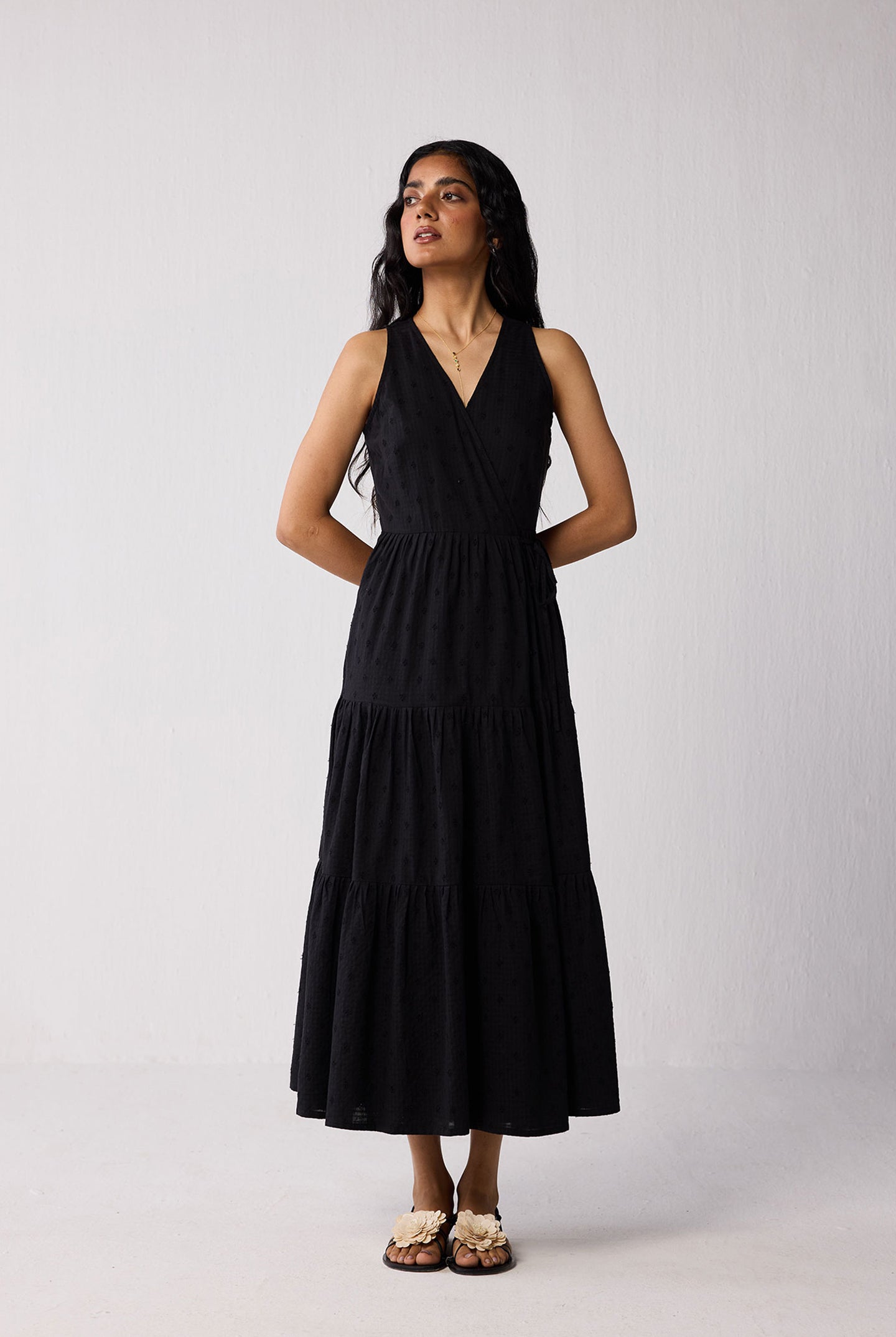 Woman wearing a black dress against a white background