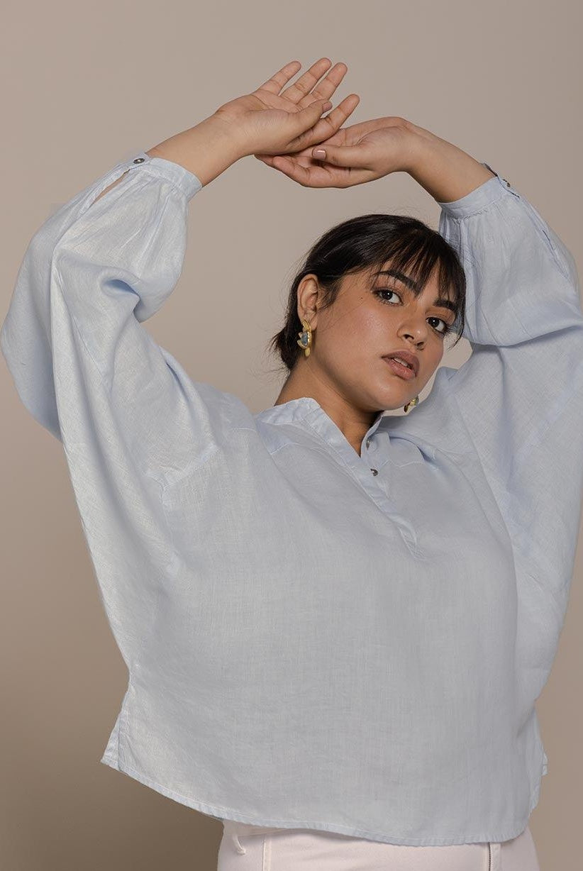 Blue top with flowy butterfly sleeves and a mandarin or Chinese collar