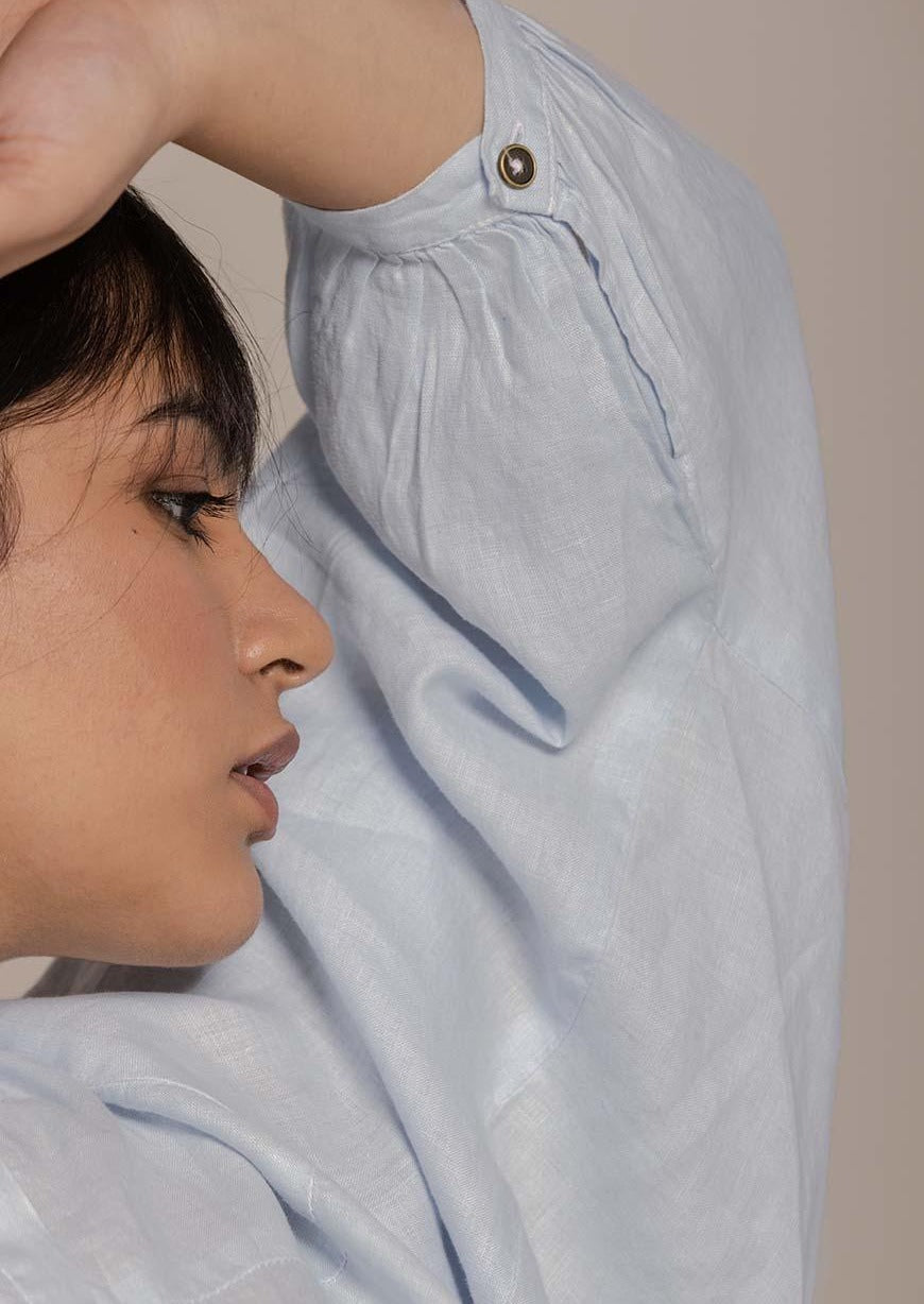 Blue top with flowy butterfly sleeves and a mandarin or Chinese collar