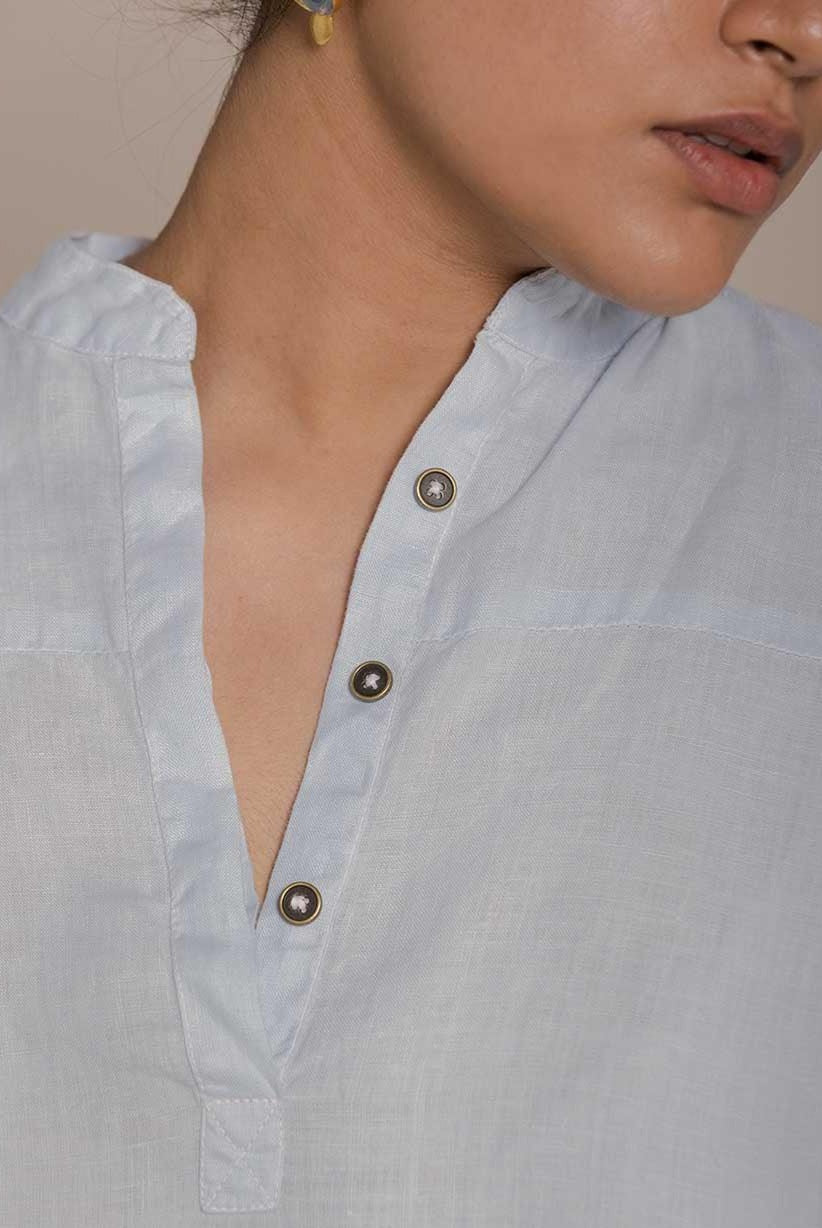 Blue top with flowy butterfly sleeves and a mandarin or Chinese collar