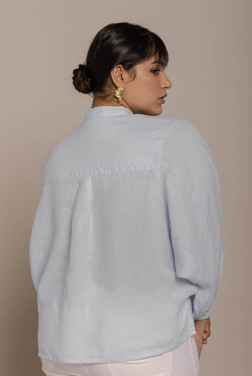 Blue top with flowy butterfly sleeves and a mandarin or Chinese collar