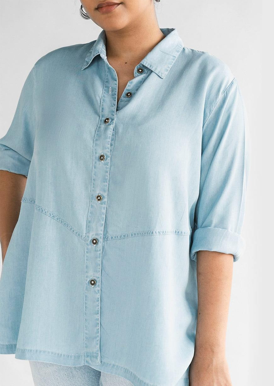 Close-up of the Reistor Ready for the World Shirt in Blue Denim, featuring a button-front design, rolled sleeves and lightweight denim fabric for everyday wear.