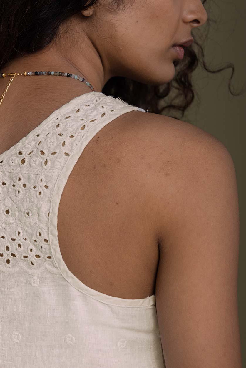 off white T back top with a v neck and embroidered details front and behind