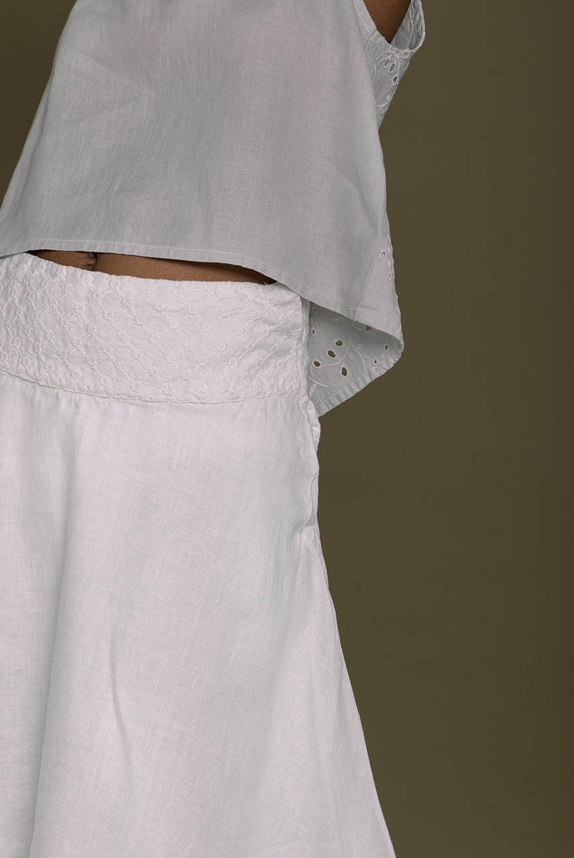 white straight comfort-fit skirt with an embroidered belt to accentuate the waistline.