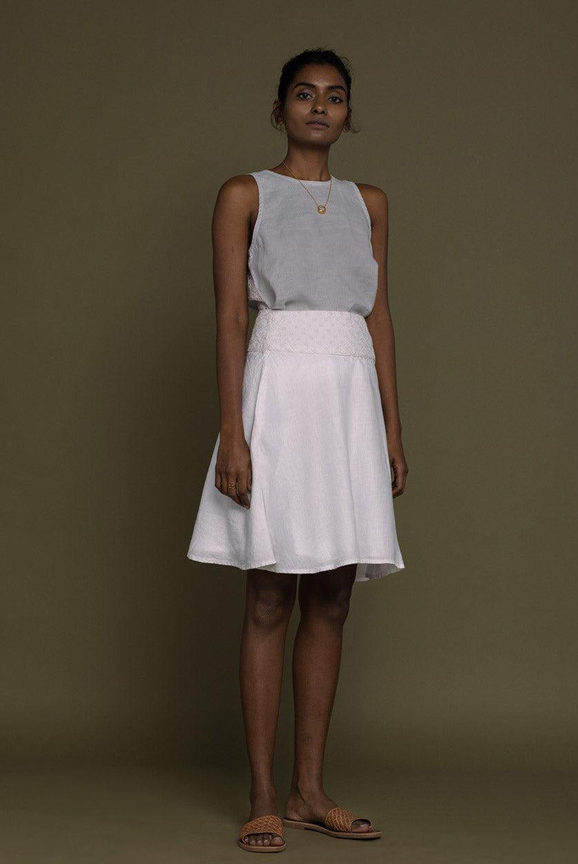 white straight comfort-fit skirt with an embroidered belt to accentuate the waistline.